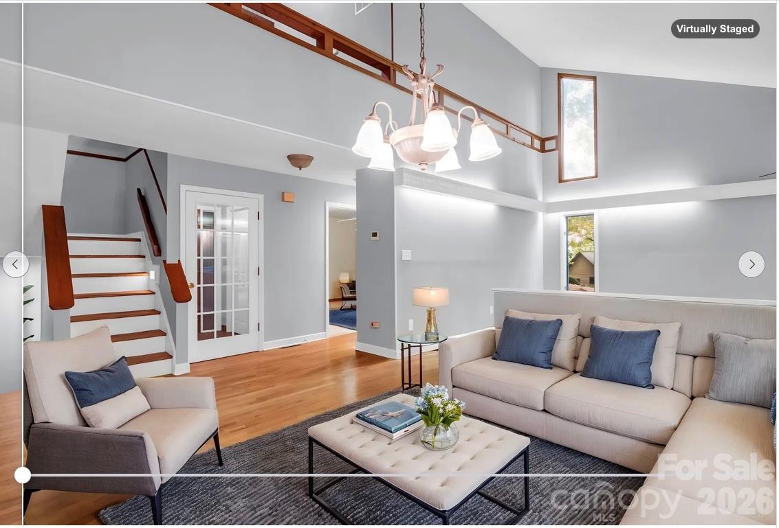 virtually staged as living room: View from Dining Room to Foyer & Stairs - 10 Chestnut Ridge Road, Mills River
