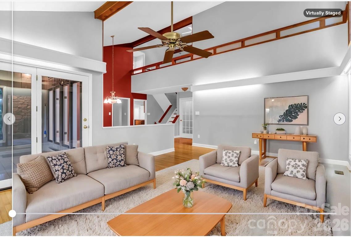 virtually staged: Family Room with doors to the covered patio - 10 Chestnut Ridge Road, Mills River