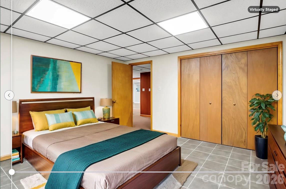 virtually staged: Lower level finished Flex Space / Storage Room with tile floor - 10 Chestnut Ridge Road, Mills River