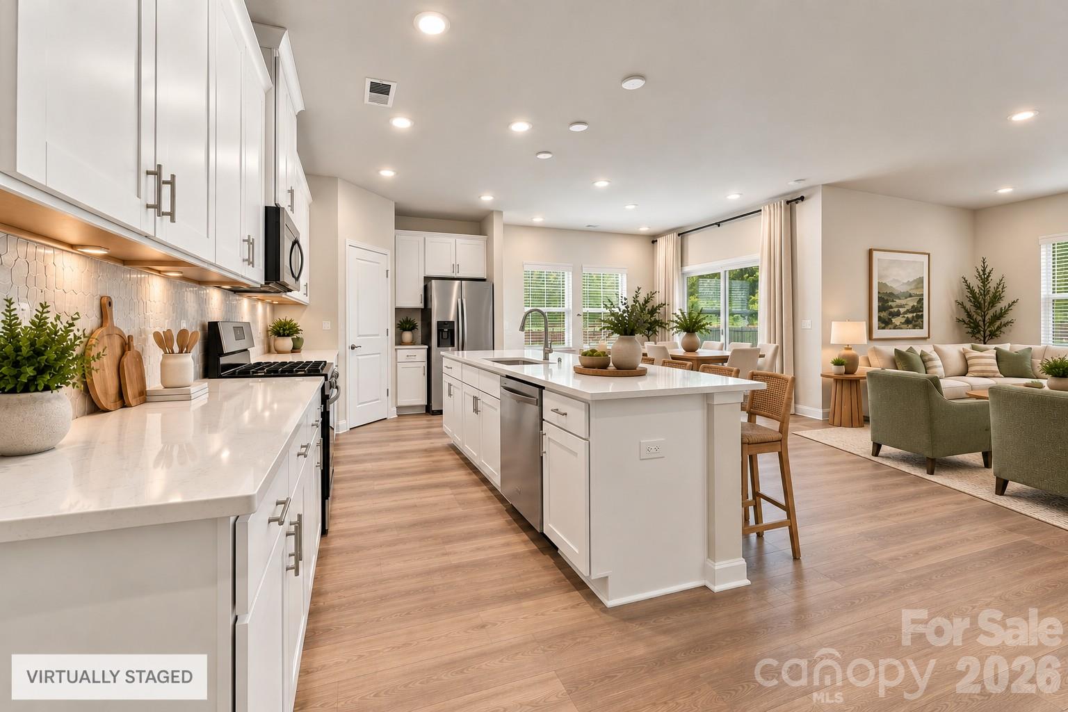 Open floor plan- white kitchen opens to great room and dining area with easy access to covered porch! - 151 Bird Dog Drive, Mooresville