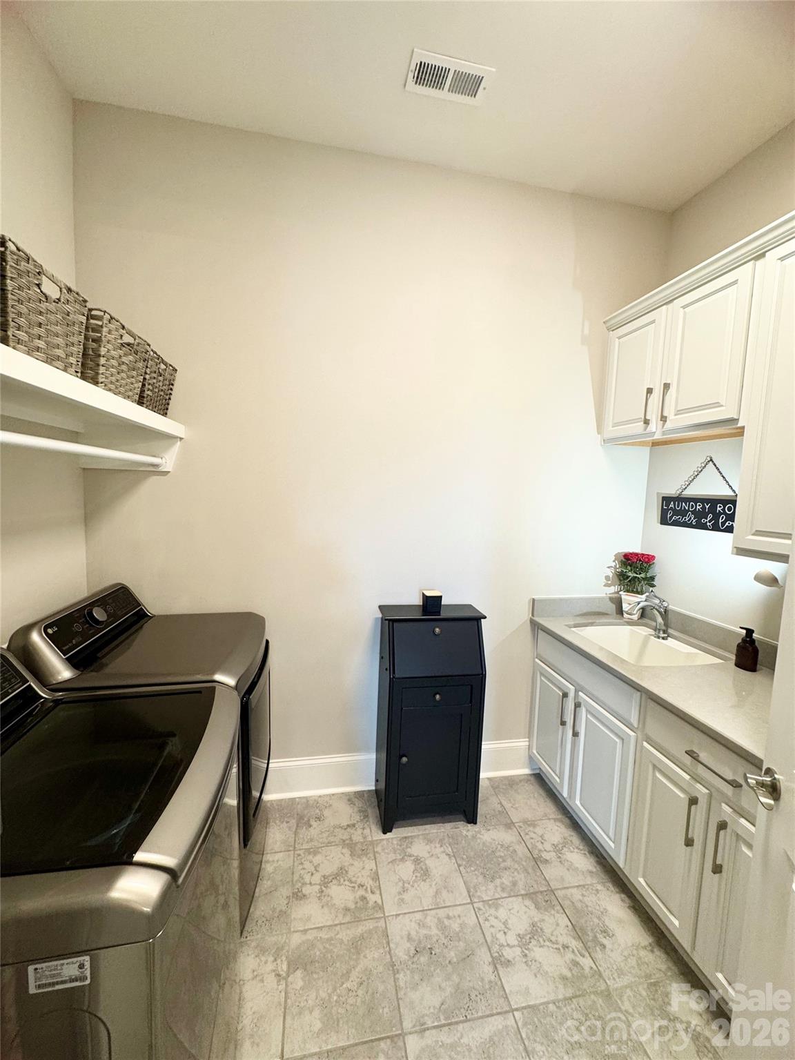 Laundry room with built in utility sink and custom storage - 9065 Treetop Way NW, Concord