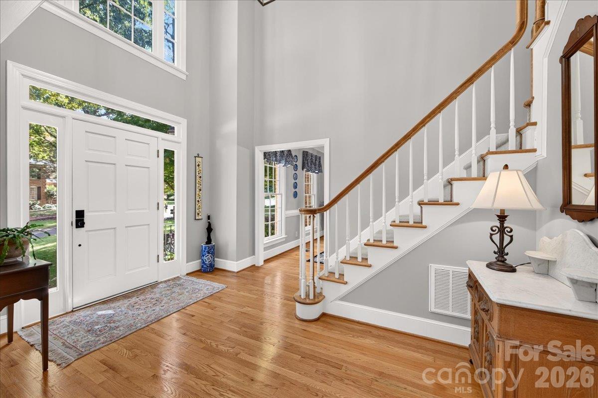 Lovely wood flooring in this 2-story foyer and throughout the main floor. - 5919 Derry Hill Place, Charlotte