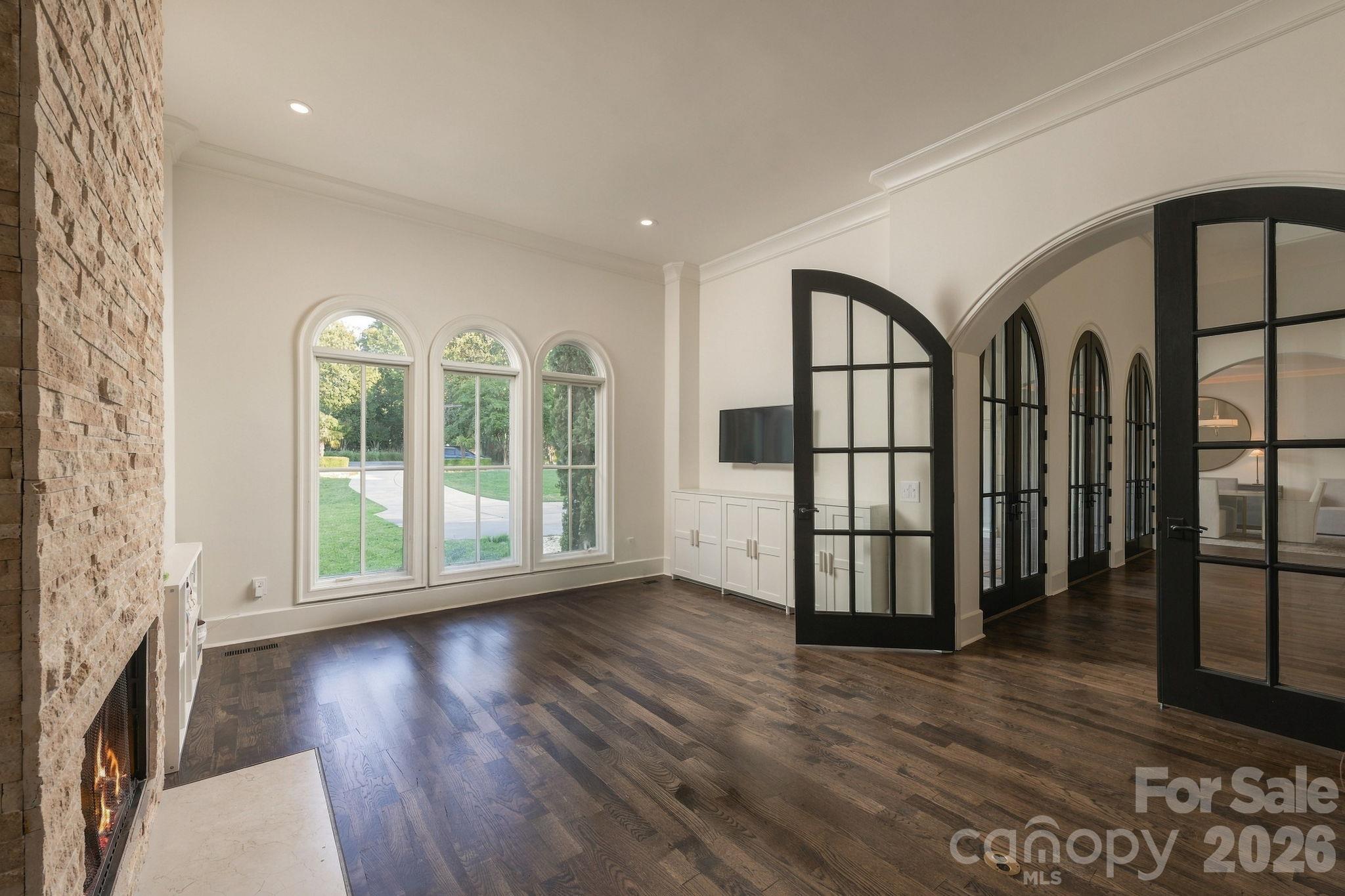 This main floor office is right off the foyer with stone fireplace and arched doors. - 21215 Senlac Lane, Cornelius