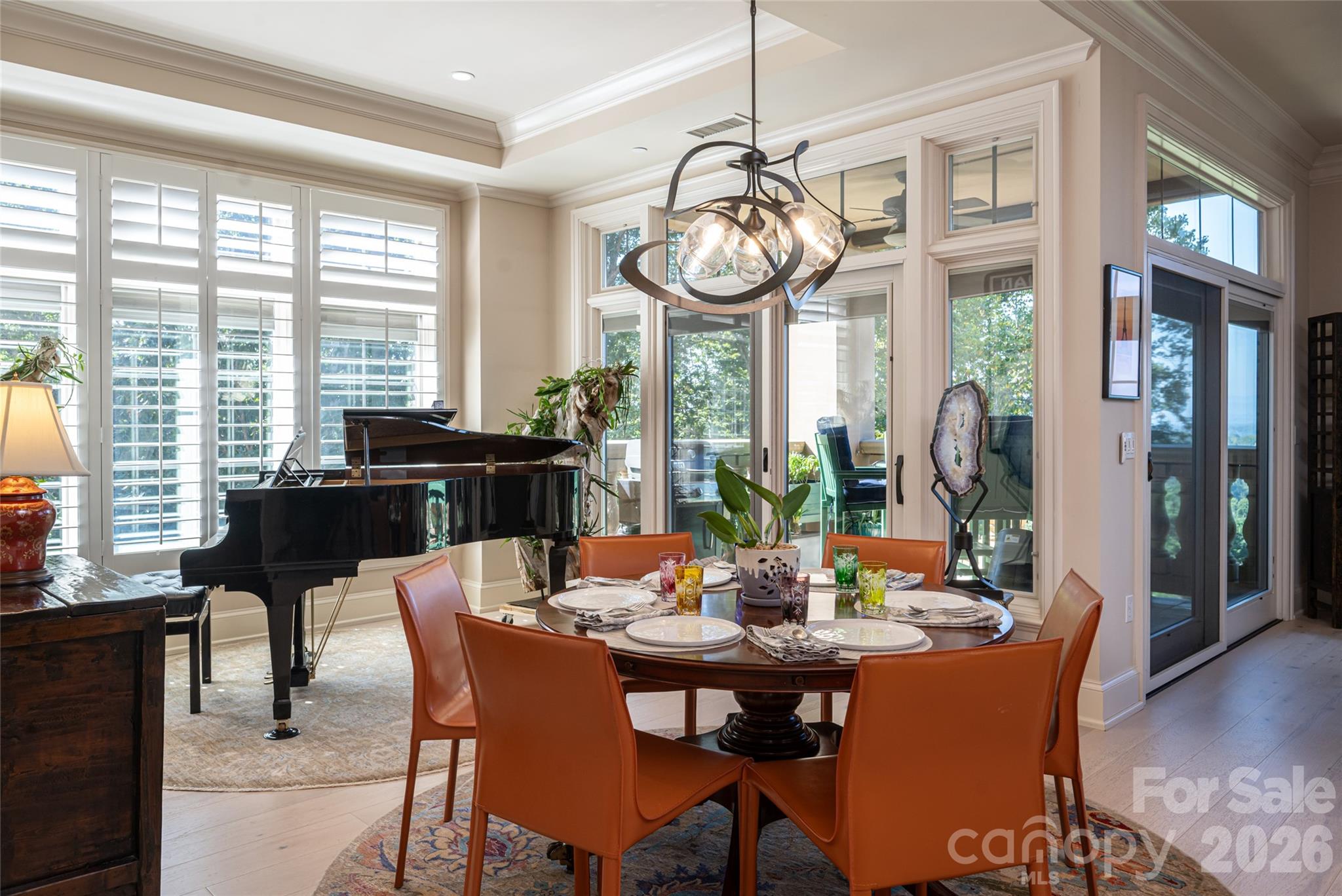 Large dining area which currently accommodates a baby grand piano and a dining table. - 288 Macon Avenue, Asheville