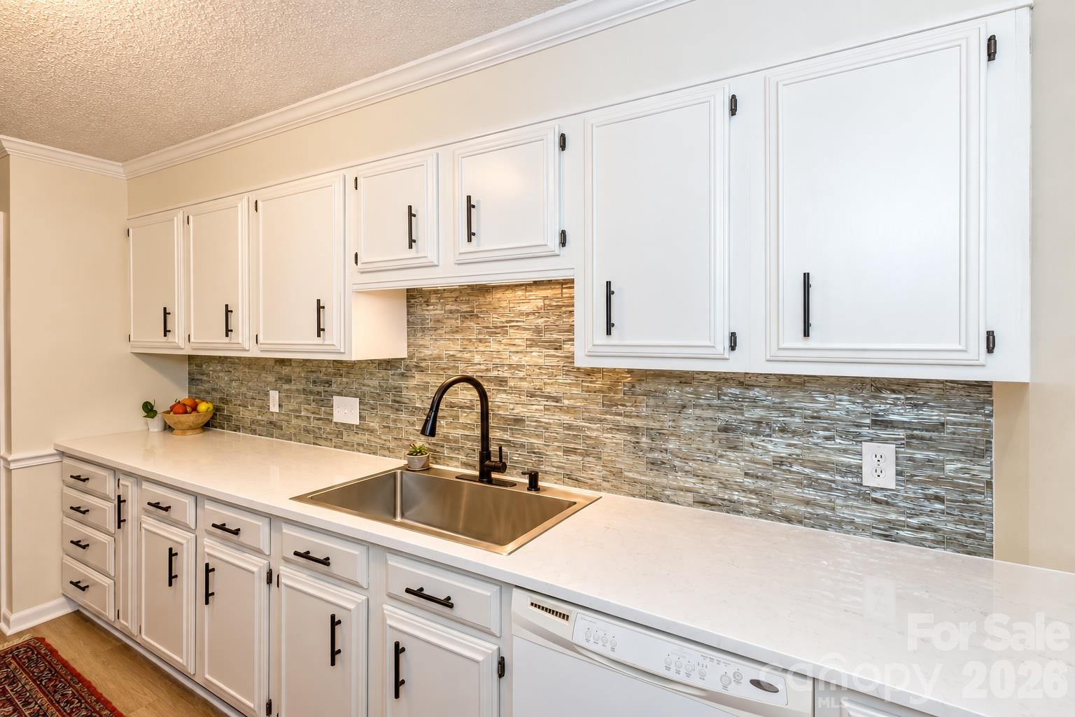 Freshly renovated kitchen with quartz counters, deep sink and sleek glass back splash - 503 Crowfields Lane, Asheville