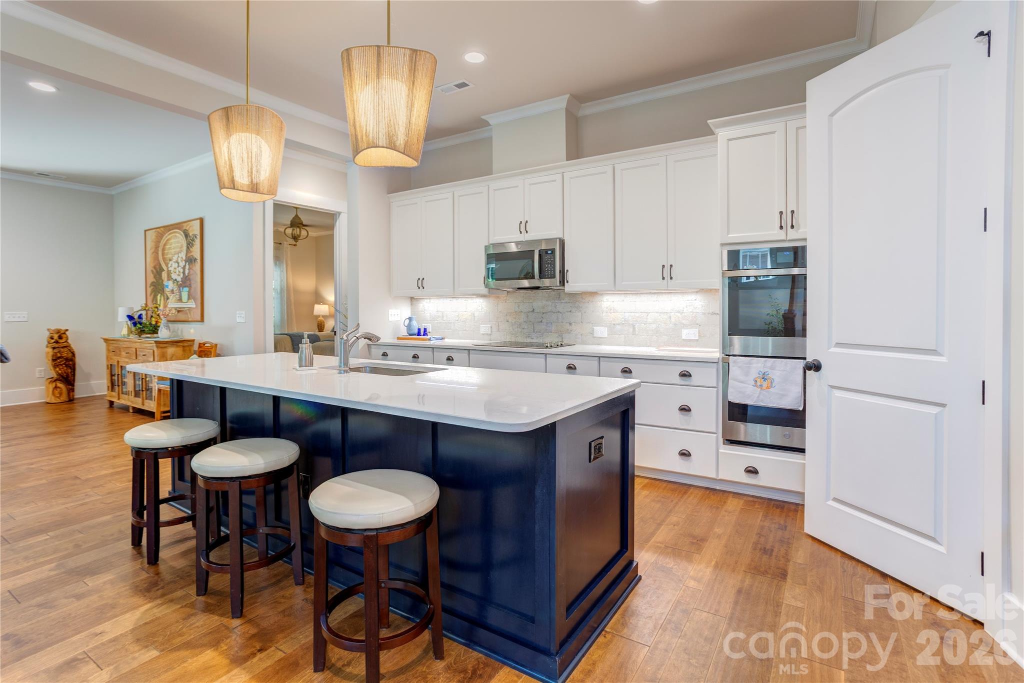 The kitchen is the heart of this home, centered around a generous island for cooking and gathering. - 158 Fulworth Drive NW, Concord