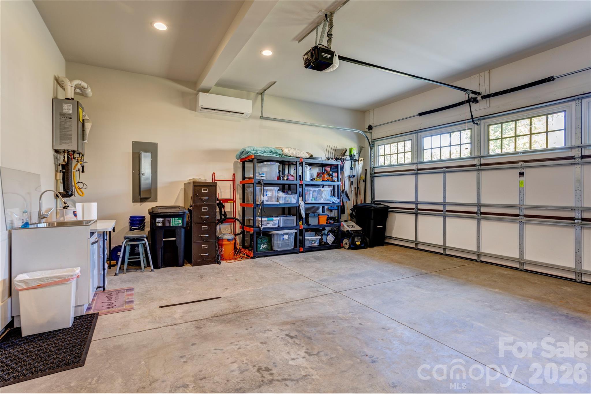 The heated and cooled garage, with its own mini split, makes a comfortable workshop, gym, or hobby space year round. - 158 Fulworth Drive NW, Concord