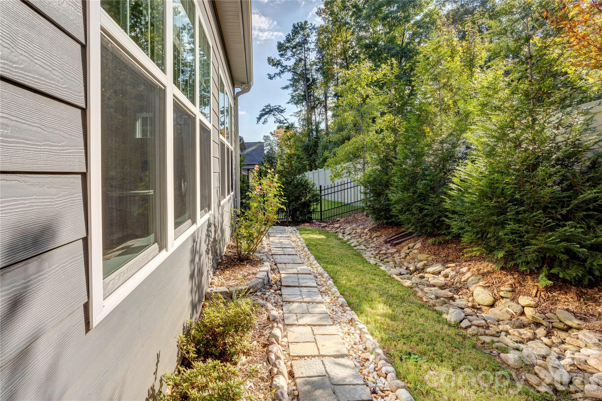 A well-kept side yard rounds out the outdoor space. - 158 Fulworth Drive NW, Concord
