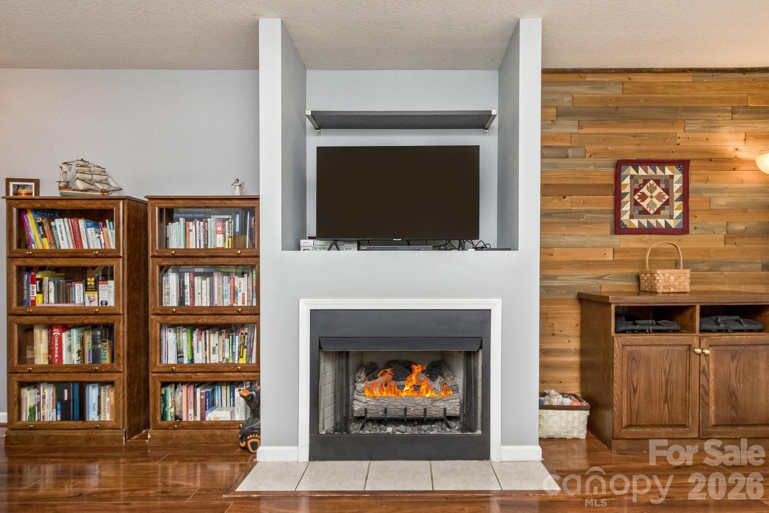 Gas fireplace with built in media center over fireplace. Open floor plan living area - 5 Lilac Fields Way, Arden