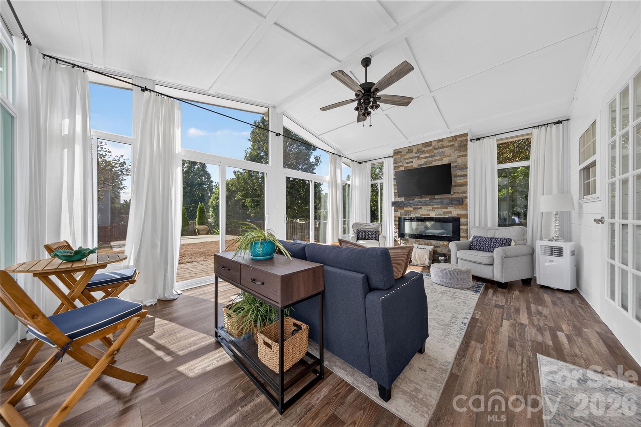 Sunroom overlooking fully fenced backyard with vaulted ceilings and electric fireplace - 5725 Lindley Crescent Drive, Indian Trail