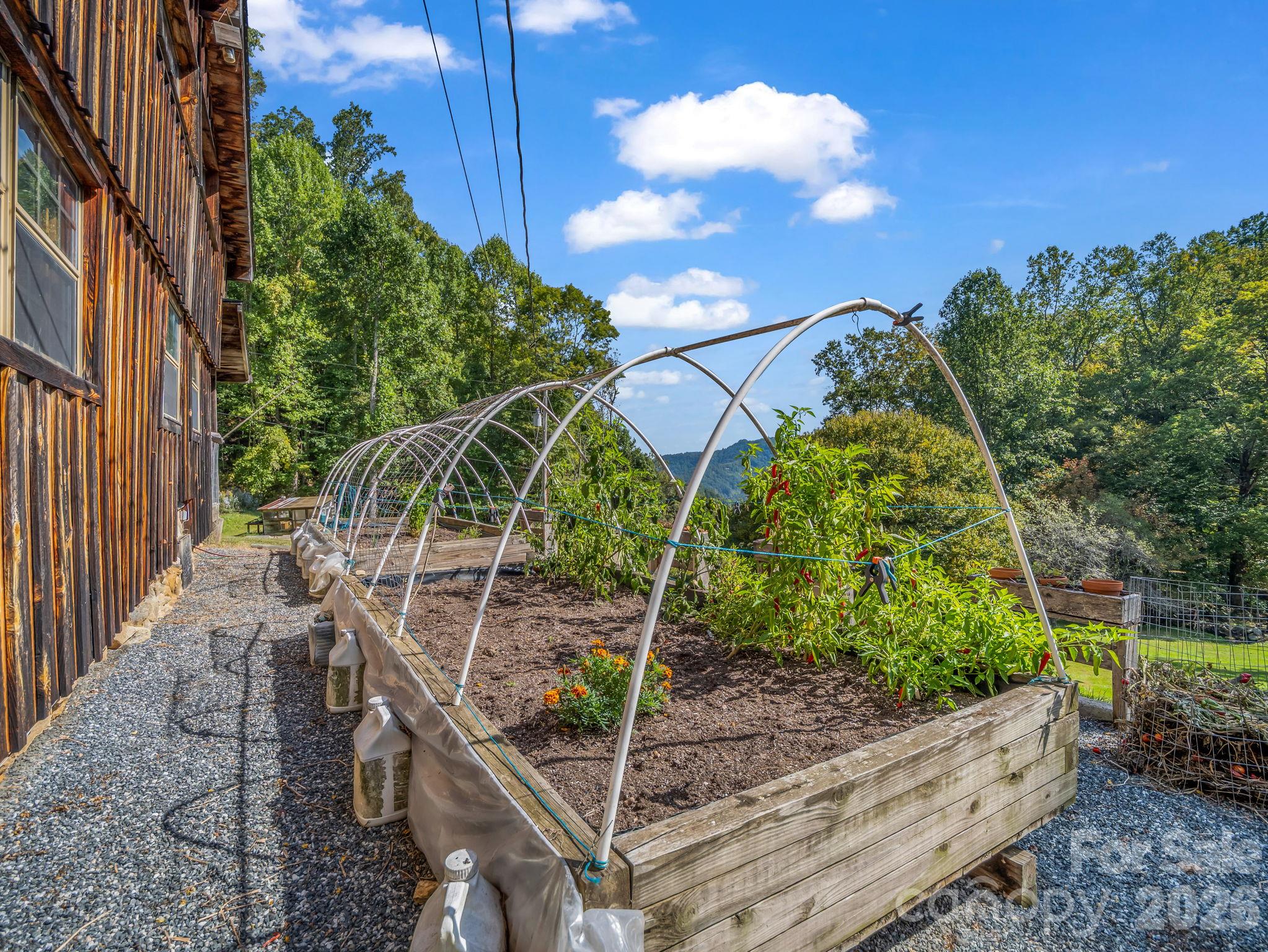 Raised garden beds just outside the front door - 765 Hawk Ridge Lane, Marshall