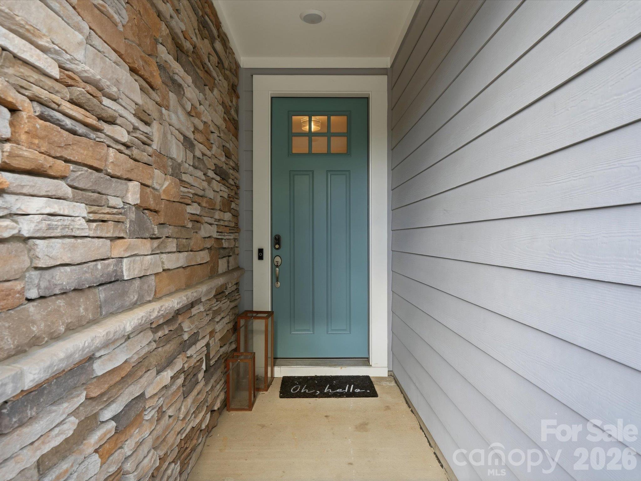 Covered front entry with stacked stone wall, Craftsman-style front door with glass panes, and keypad lock at this Charlotte NC end-unit townhome. - 337 Belton Street, Charlotte