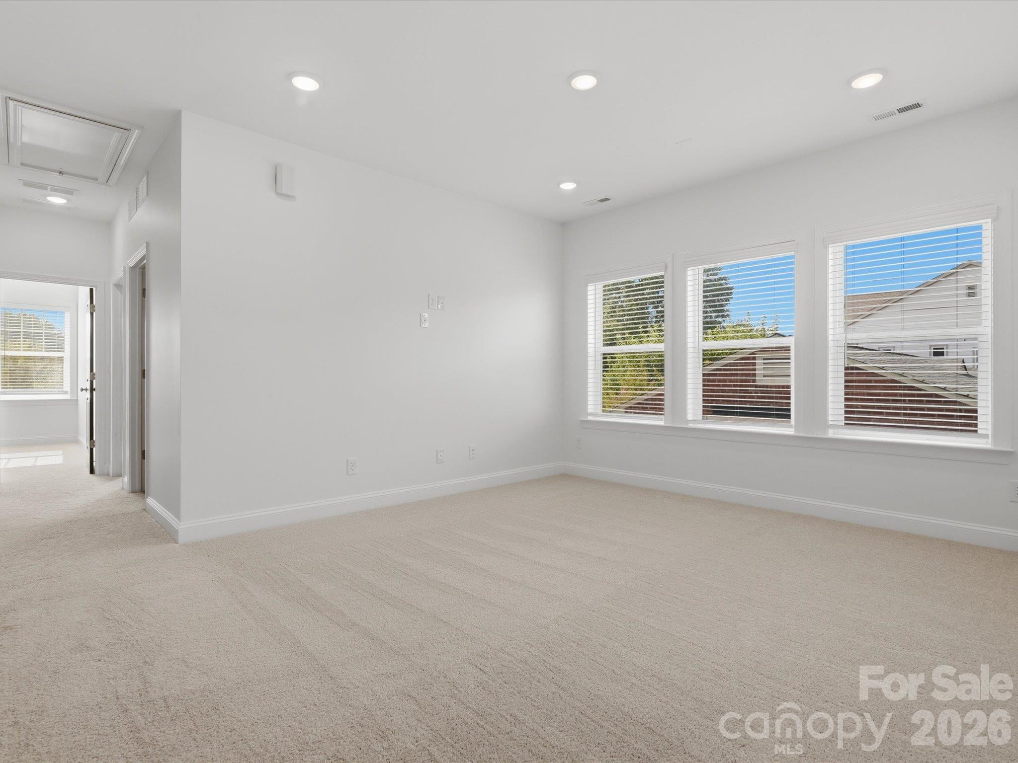 Oversized upstairs bonus room with triple windows and recessed lighting. Flexible space for a media room, home office, gym, or second living area. - 337 Belton Street, Charlotte