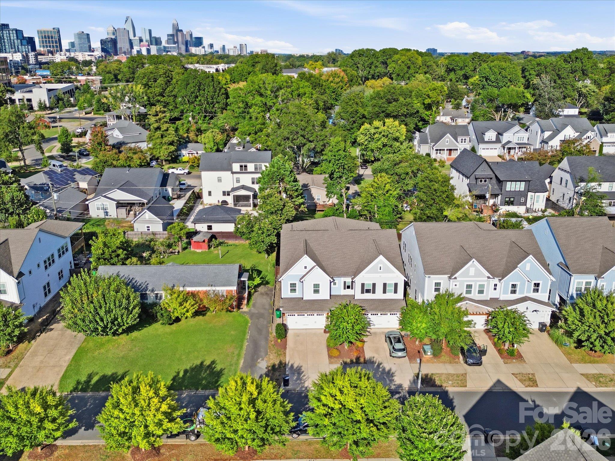 Aerial view of 337 Belton St with the Uptown Charlotte skyline in the distance, showing the 28209 location near South End dining, shopping, and entertainment. - 337 Belton Street, Charlotte