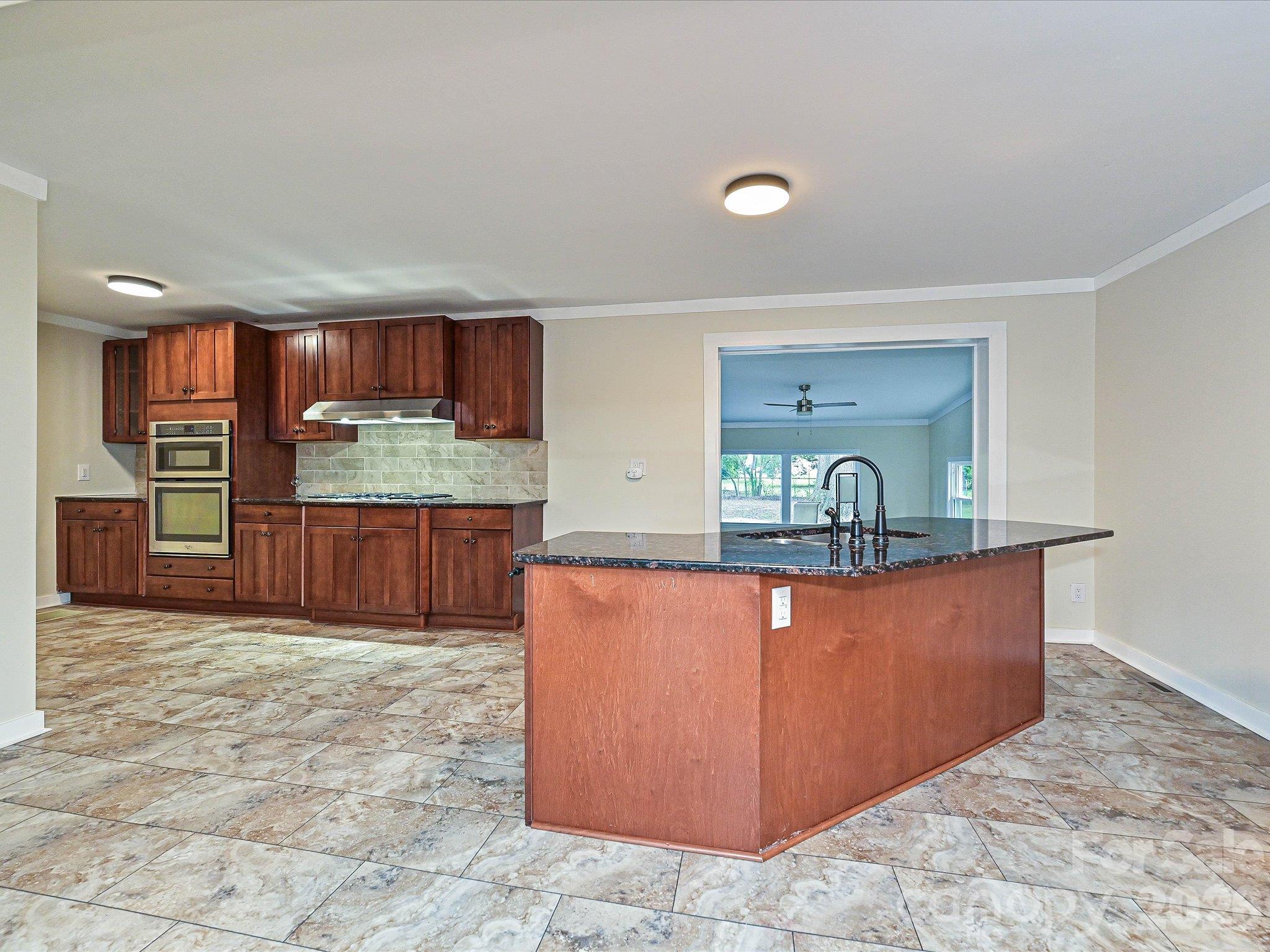 Kitchen with island - 3115 Potter Road S, Waxhaw