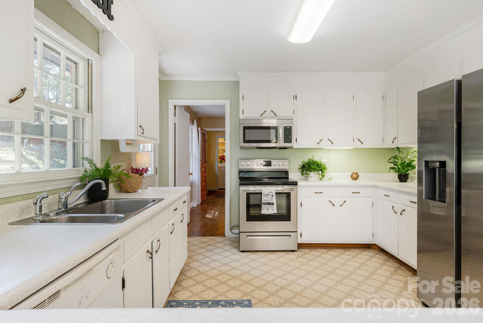 Kitchen has tons of storage and newer fridge and stove - 224 Lyndale Road, Hendersonville