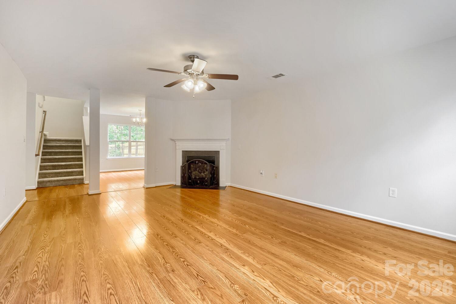 Living Room w/ Fireplace, & view of Formal Dining Room & stairs to 2nd Level - 5135 Raspberry Knoll Drive, Charlotte