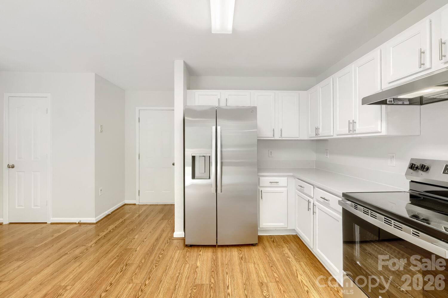 Another view of the Large Kitchen with view of the kitchen door to the Garage, next to the door is a nice size pantry & the other door is to the 1/2 bath. - 5135 Raspberry Knoll Drive, Charlotte