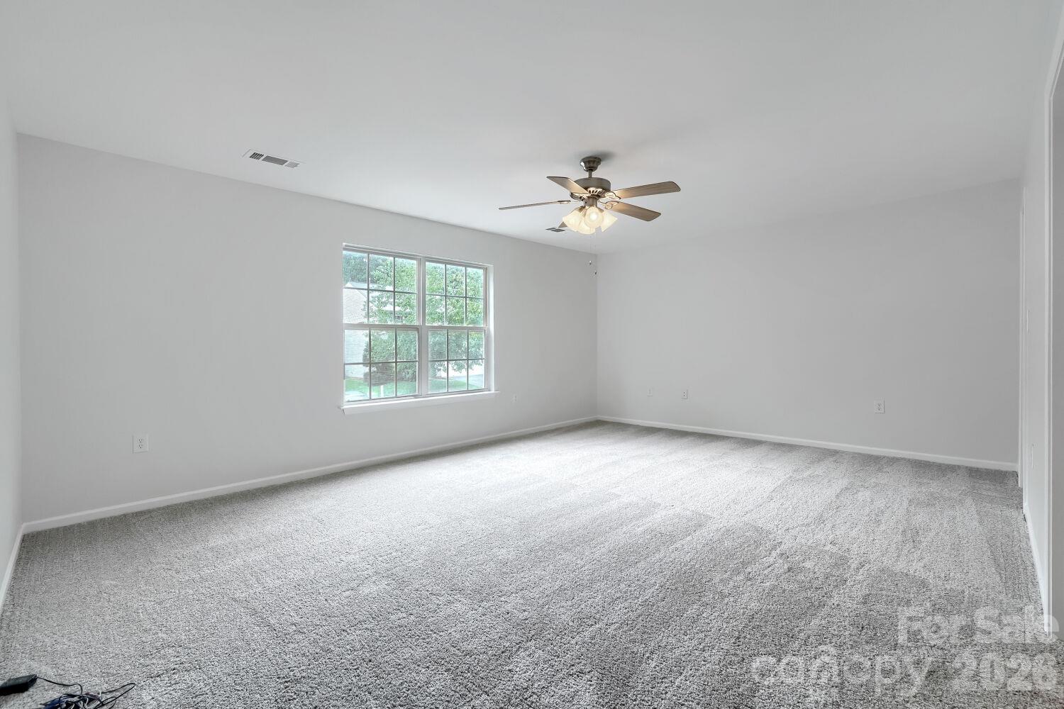 Large Primary suite on the Upper Level, New Carpet, Nice size Walk-In-Closet with shelving & ensuite bath with linen closet (view from the door to the room) - 5135 Raspberry Knoll Drive, Charlotte