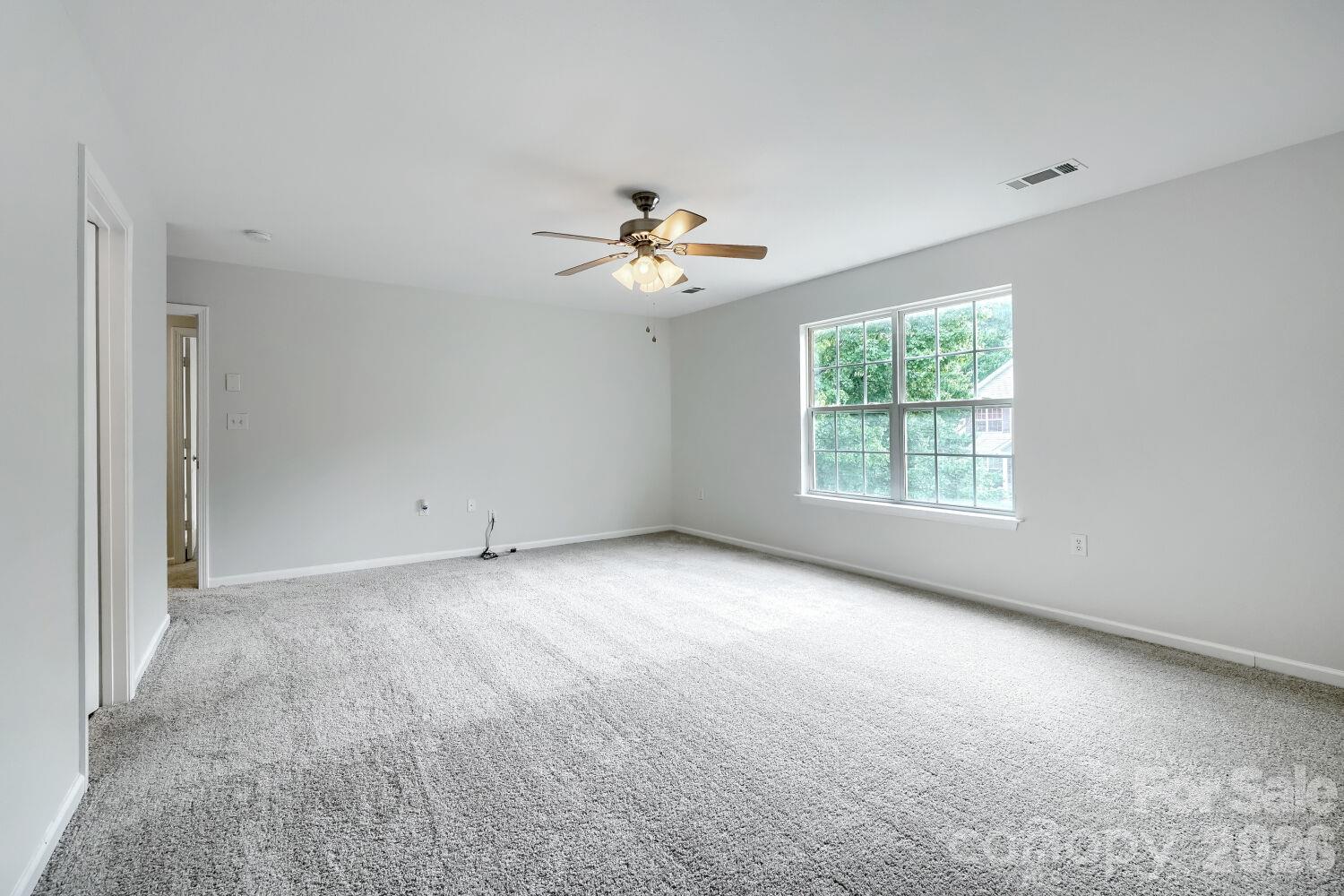 Large Primary suite on the Upper Level, New Carpet, Nice size Walk-In-Closet with shelving & ensuite bath with linen closet (view from the back of room) - 5135 Raspberry Knoll Drive, Charlotte