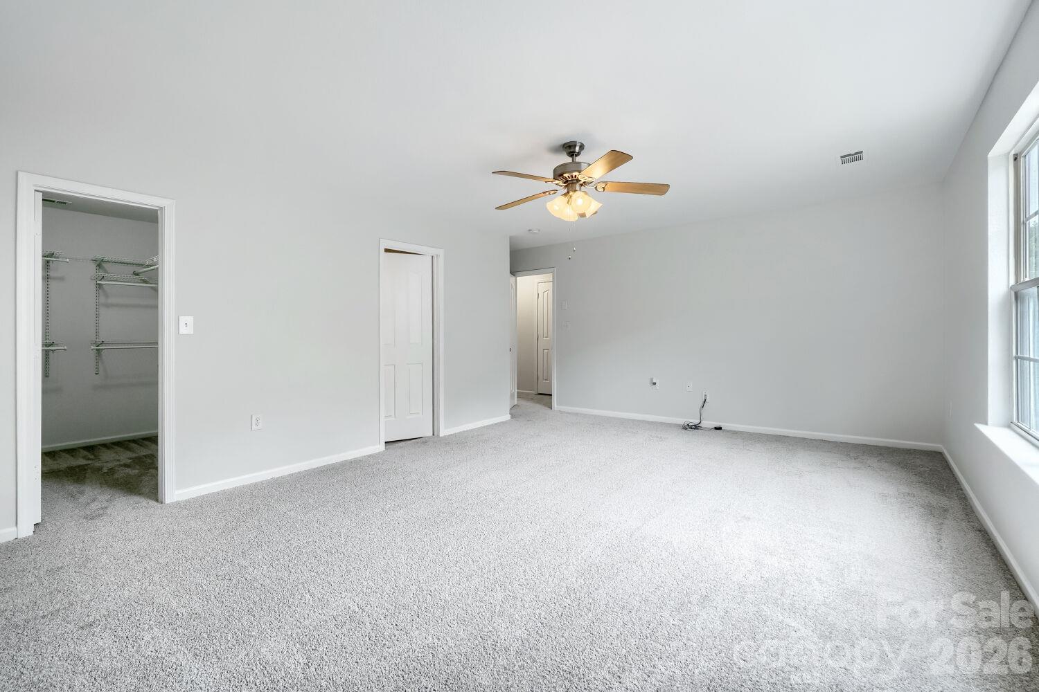 Large Primary suite on the Upper Level, New Carpet, Nice size Walk-In-Closet with shelving (view from the right side back of room) - 5135 Raspberry Knoll Drive, Charlotte