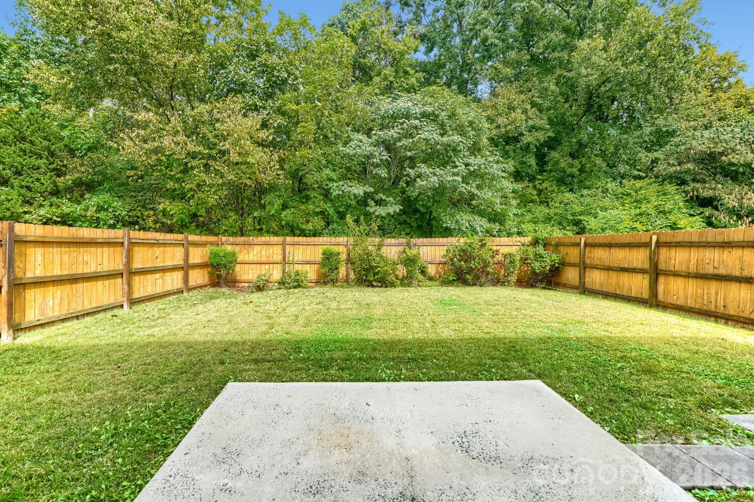 Rear view of the Large fenced in back yard - 5135 Raspberry Knoll Drive, Charlotte