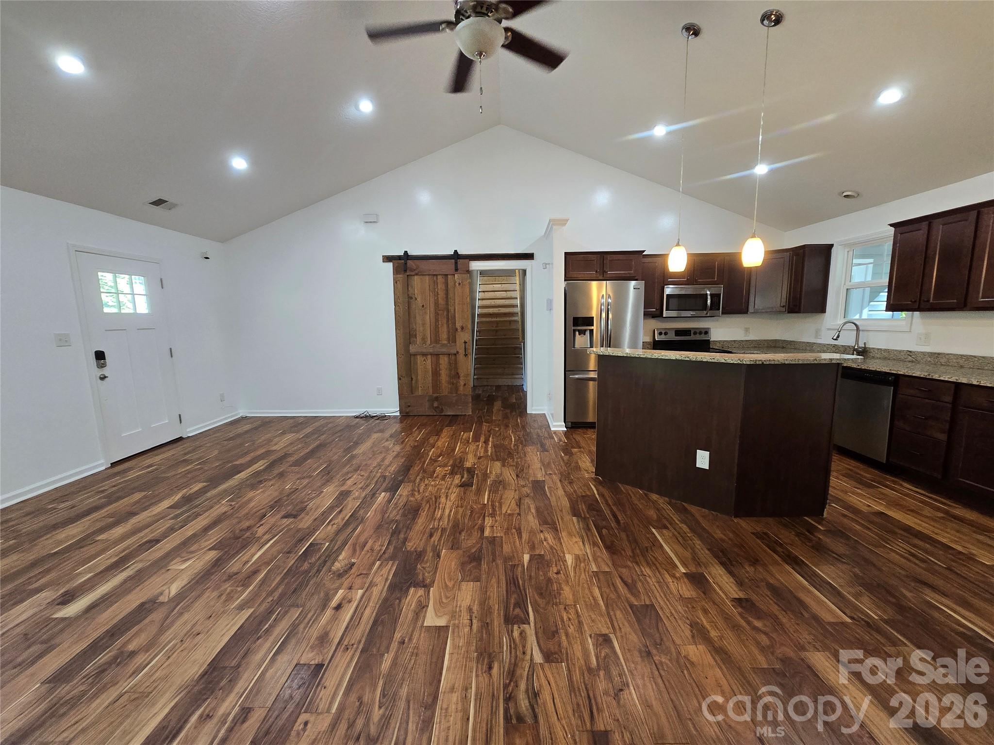 Barn doors to primary suite on right of great room - 15 Tiki Way, Candler
