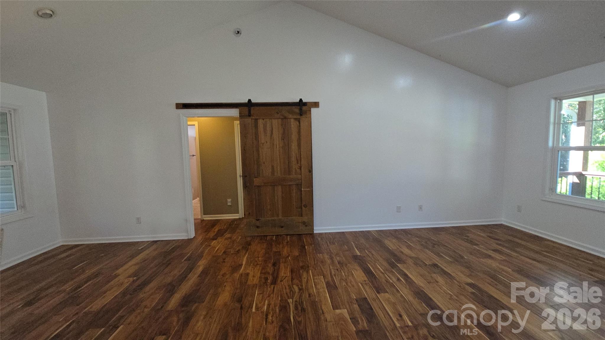 Barn doors to guest suite on left of great room. Hardwood floors - 15 Tiki Way, Candler
