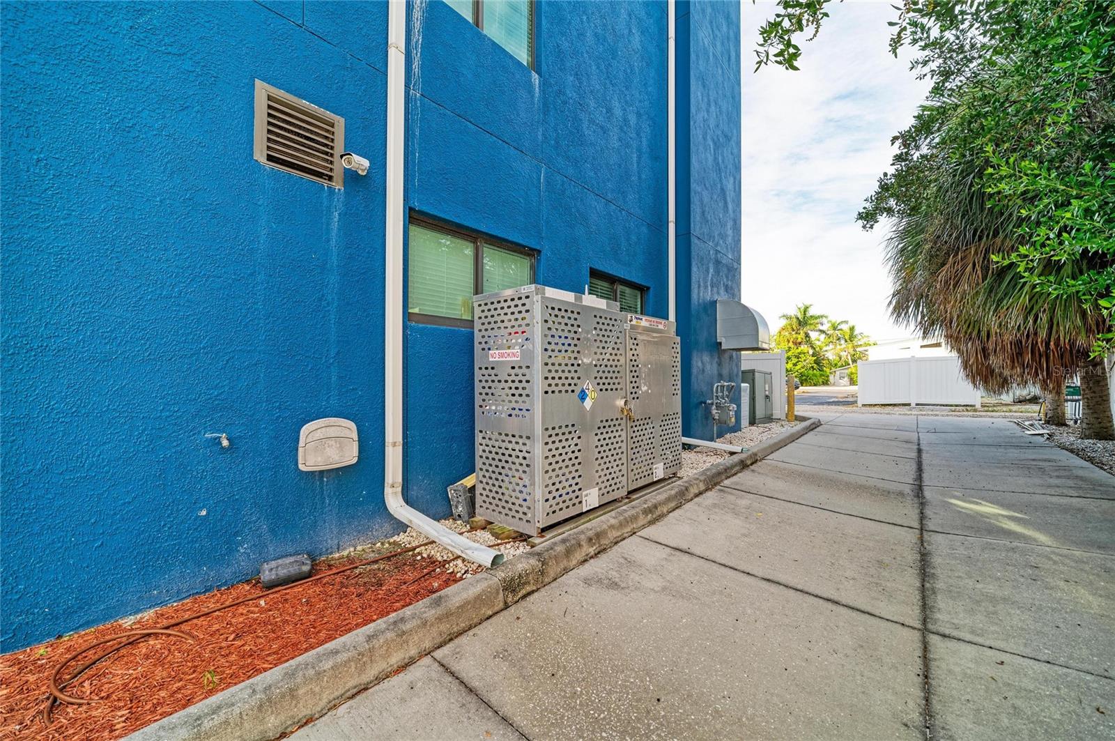 North side of building and through alley - 3004 AVENUE C, HOLMES BEACH