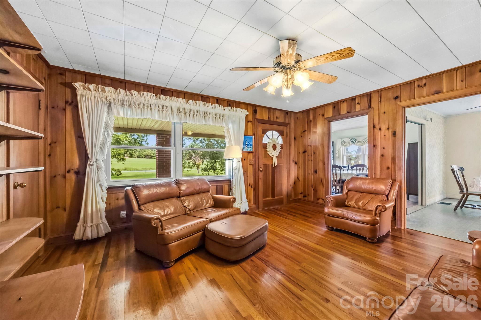 The main entrance from the front porch leads to this warm living room. There are openings to the dining room and kitchen/breakfast area. - 2925 Fallston Waco Road, Shelby