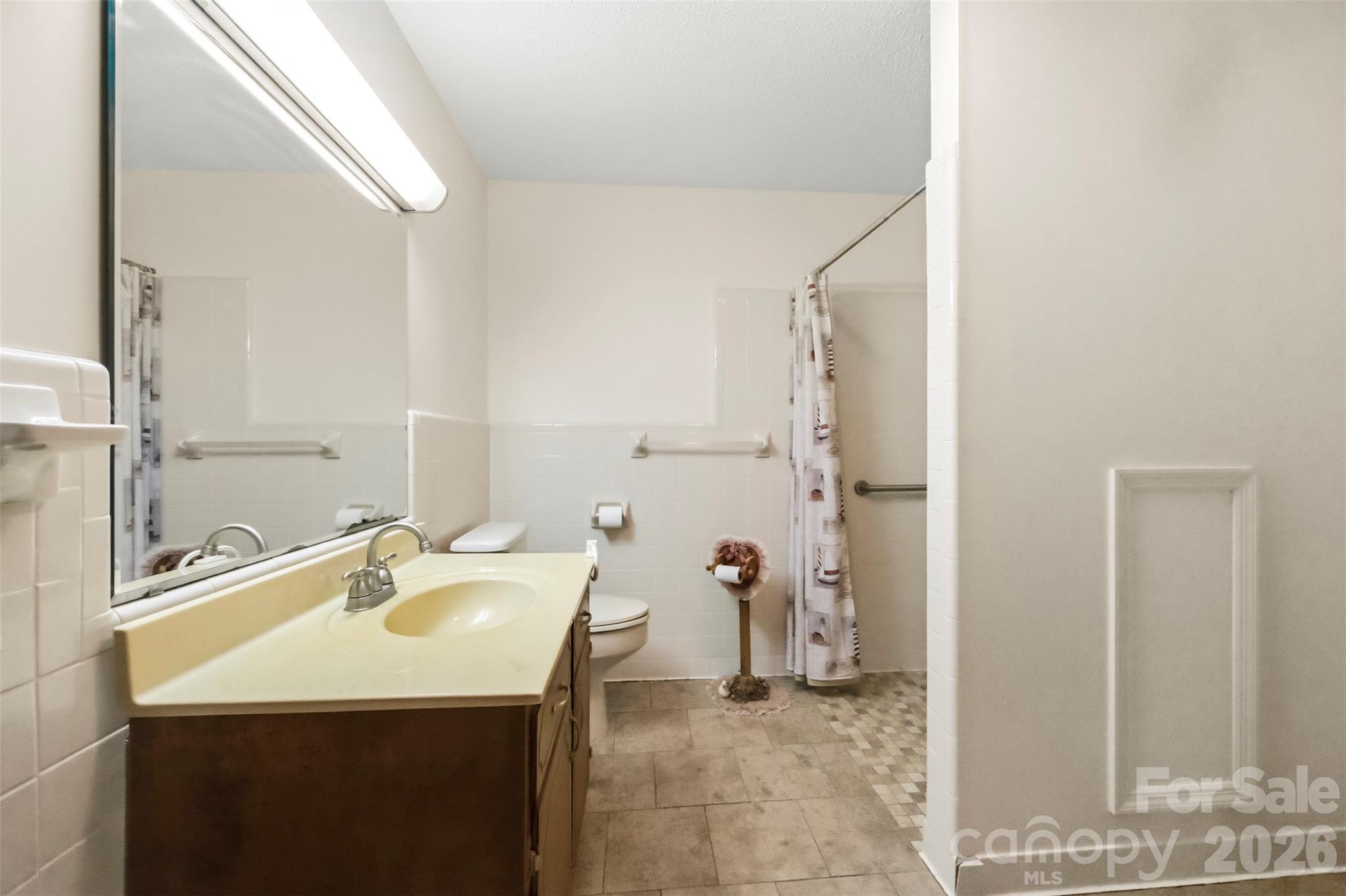 Large bathroom is part of the addition. There is an accessible, zero entry shower with grab bars. - 2925 Fallston Waco Road, Shelby