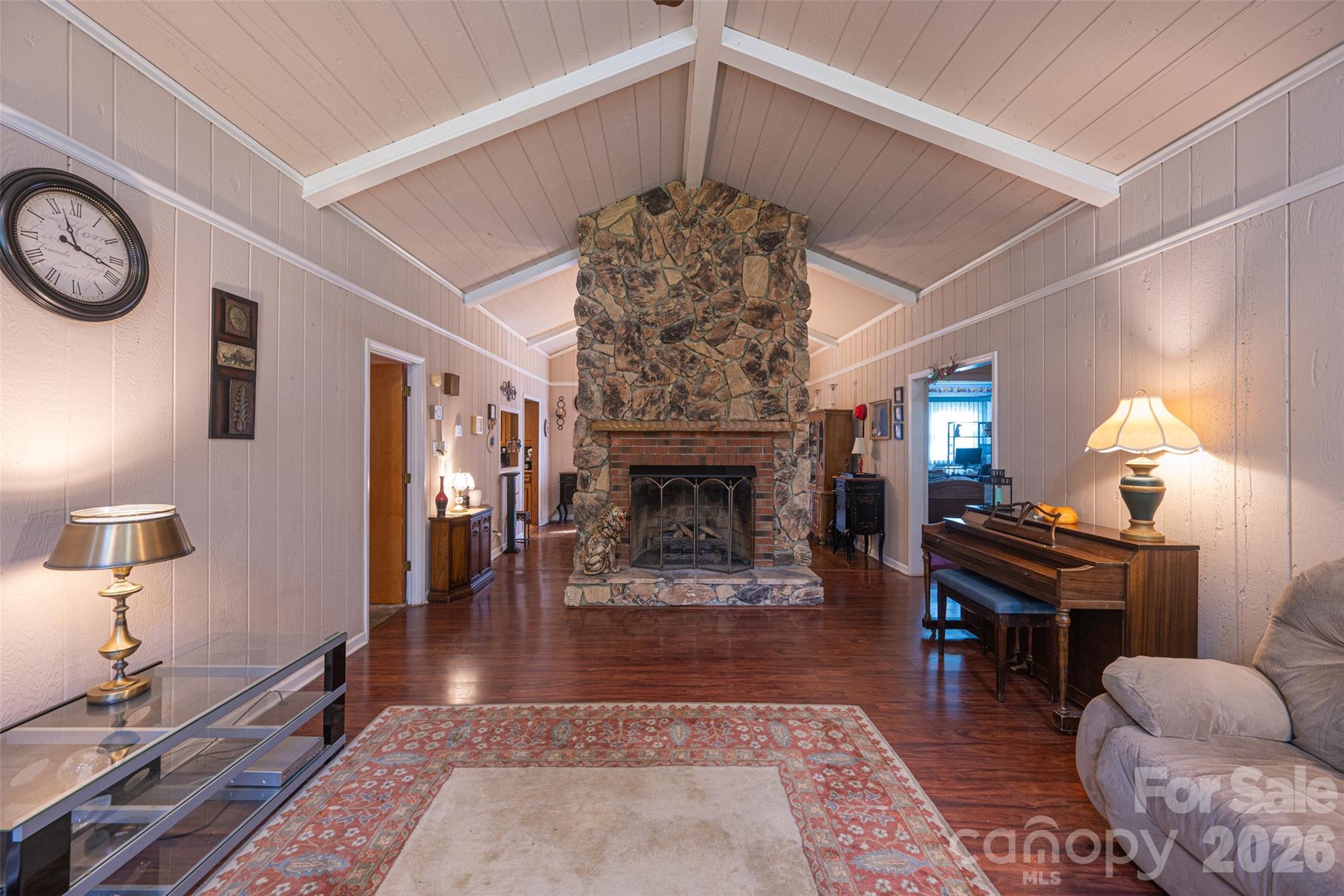 Living room with vaulted ceiling and floor to ceiling stone fireplace - 1440 Barbara Drive, Cherryville