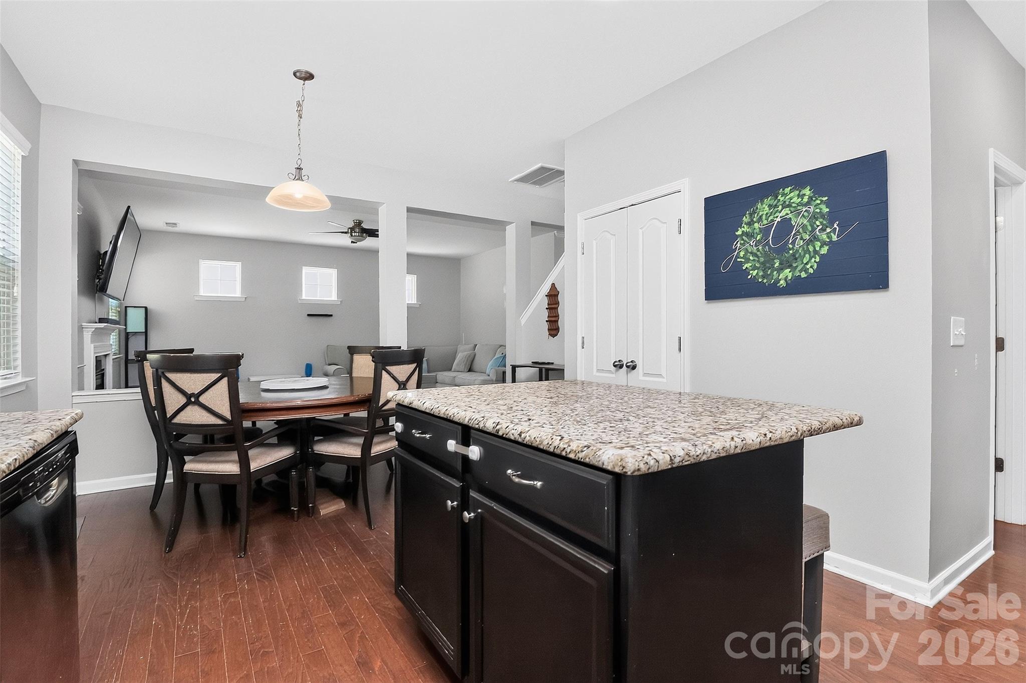 Kitchen island with 2 barstools, open to living area. - 78066 Rillstone Drive, Lancaster