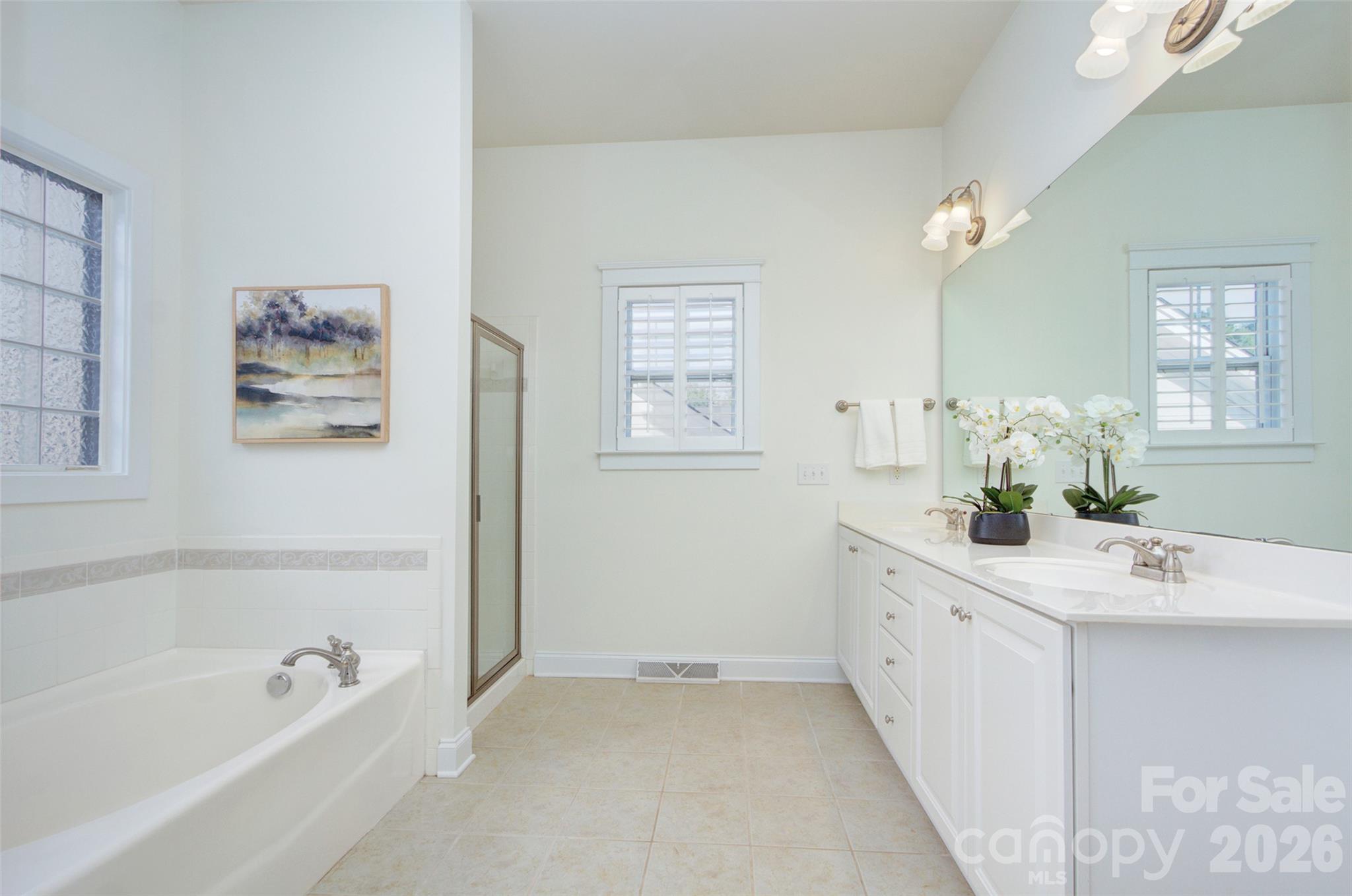 Primary bath suite with dual sinks. - 16418 Spruell Street, Huntersville