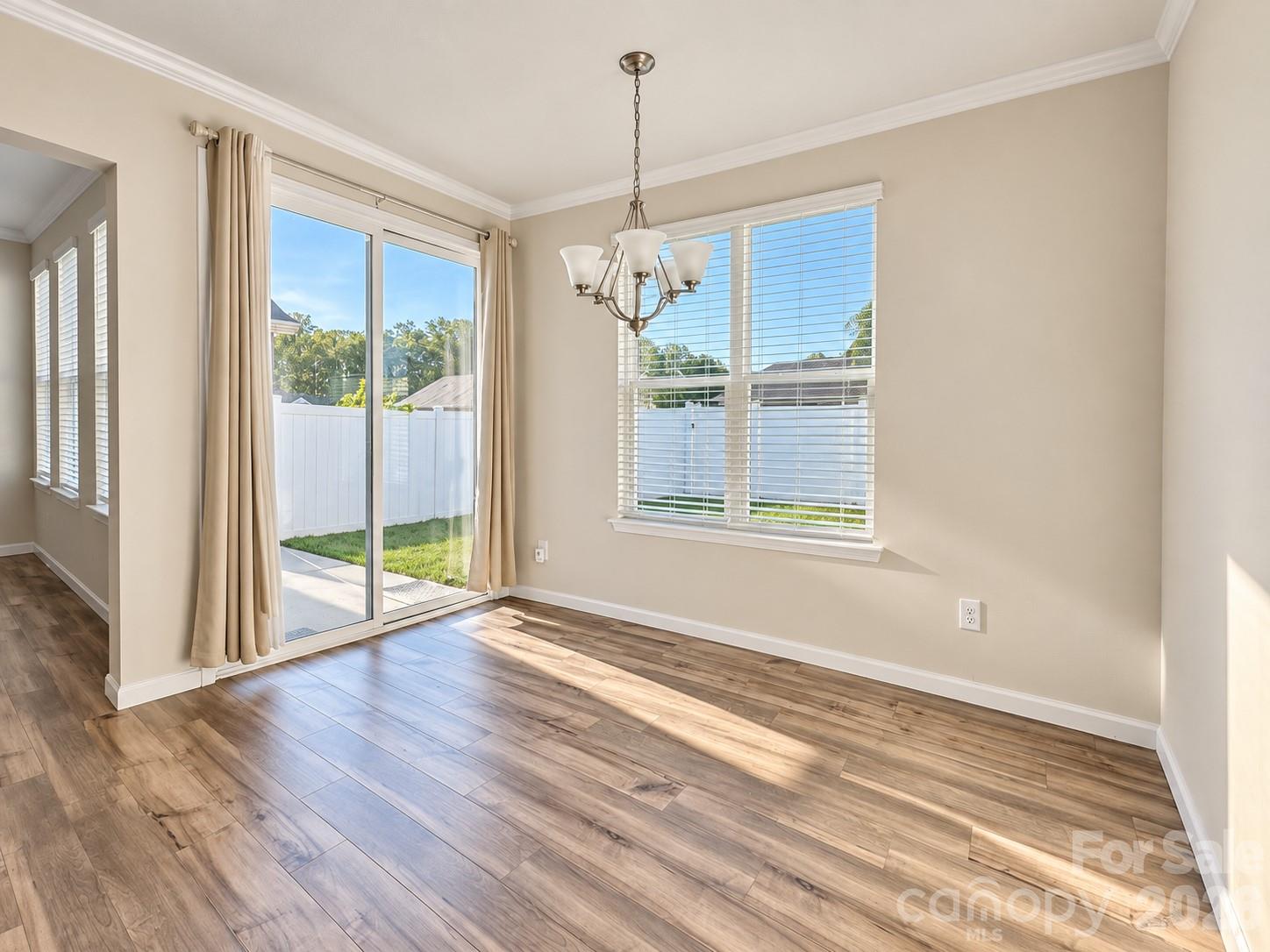 Sunlit breakfast area with easy access to the patio. - 8149 Merryvale Lane, Charlotte