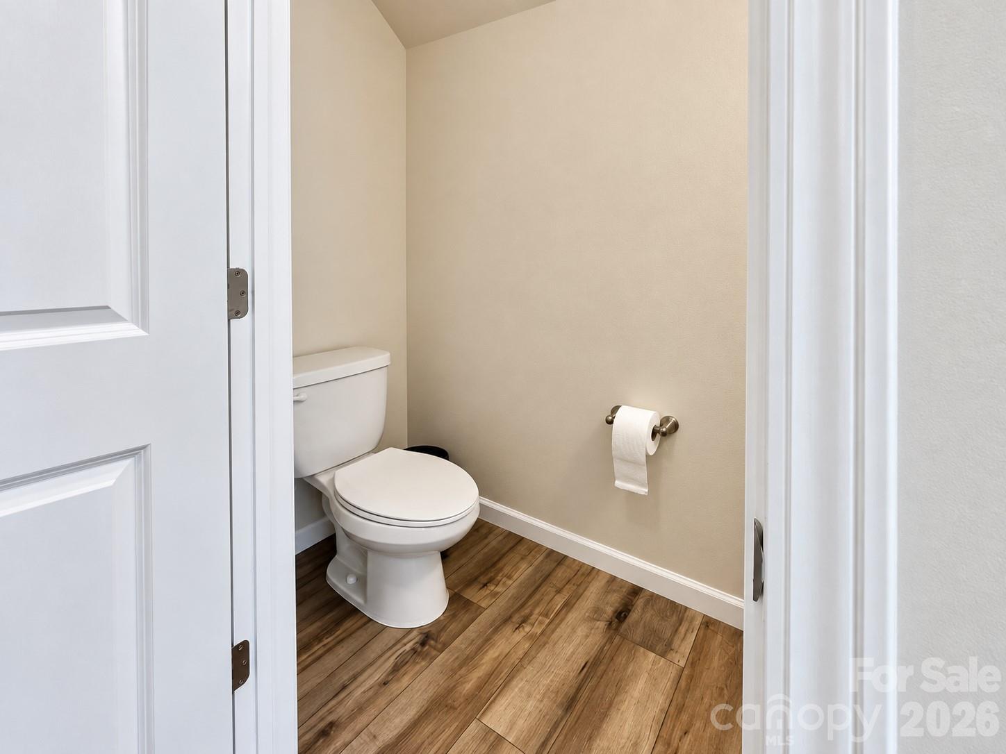 Half bathroom on the main floor. - 8149 Merryvale Lane, Charlotte