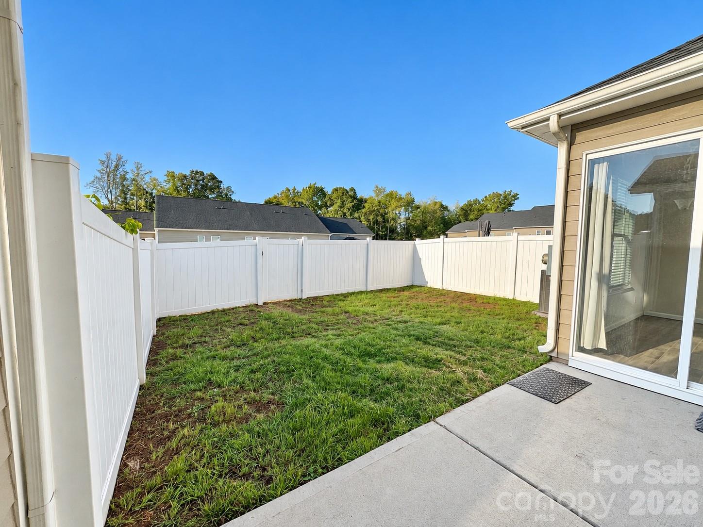 Back patio with fenced in yard. Perfect for entertaining! - 8149 Merryvale Lane, Charlotte