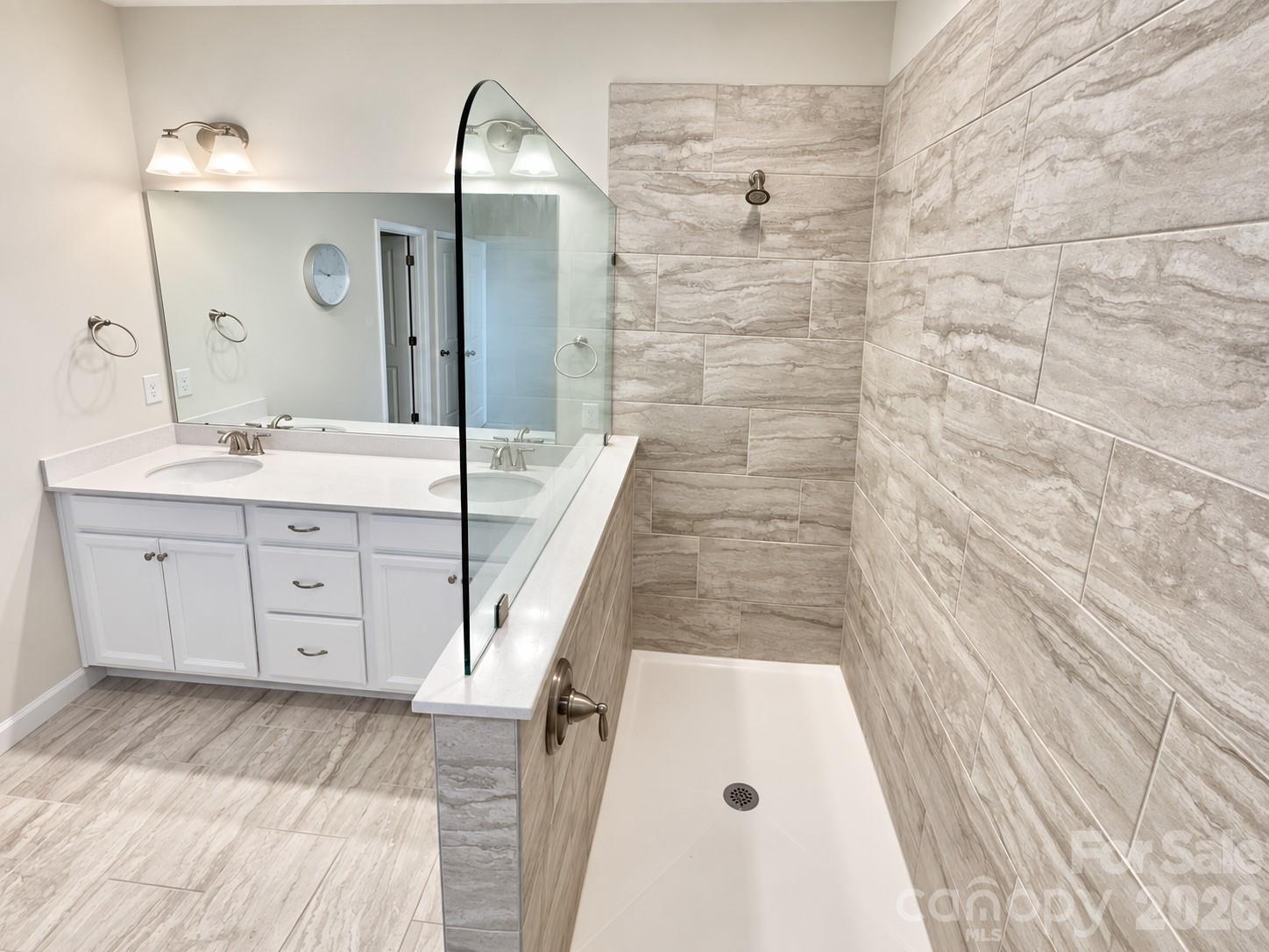 Primary bathroom. Dual vanities and a gorgeous tiled shower. - 8149 Merryvale Lane, Charlotte