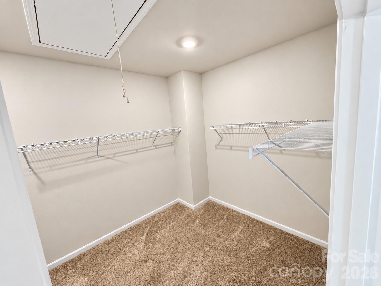 Spacious primary closet with plenty of room to organize. - 8149 Merryvale Lane, Charlotte