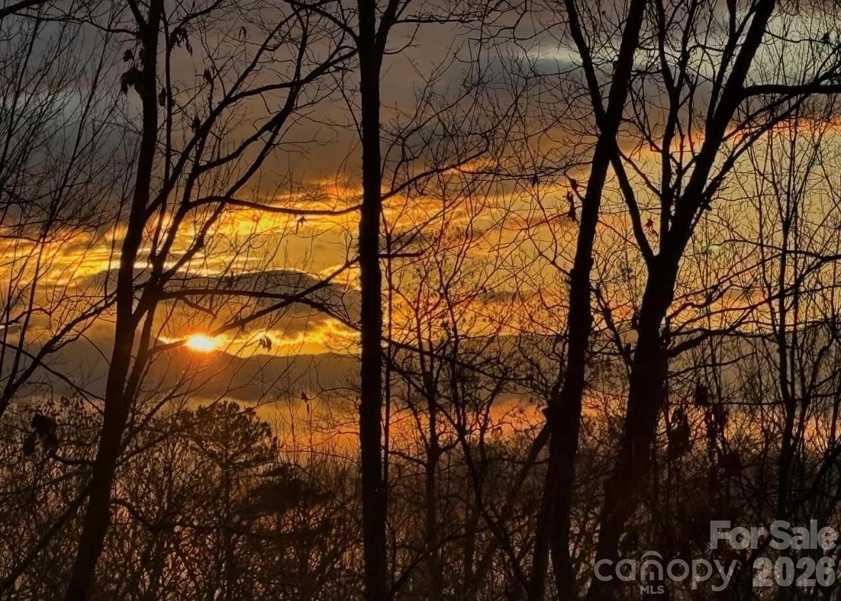 Living room view of a winter sunset over the Craggy Mountains. - 115 Laurel Wood Drive, Mars Hill