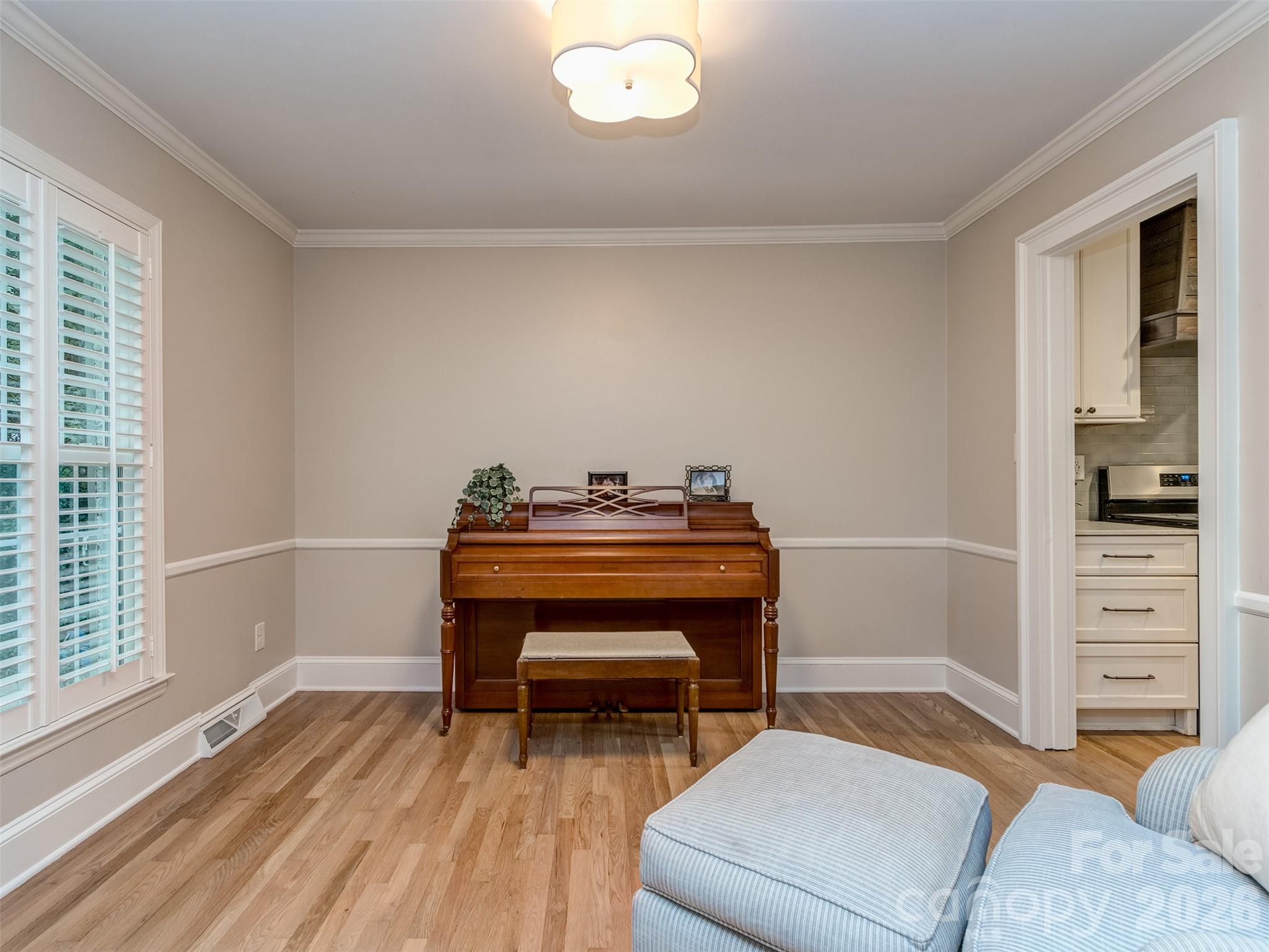 The den is a perfect place for a large home office, study, or music studio! Site finished hardwoods, extensive molding, & custom blinds are present throughout the main living areas. - 6129 Page Court, Charlotte