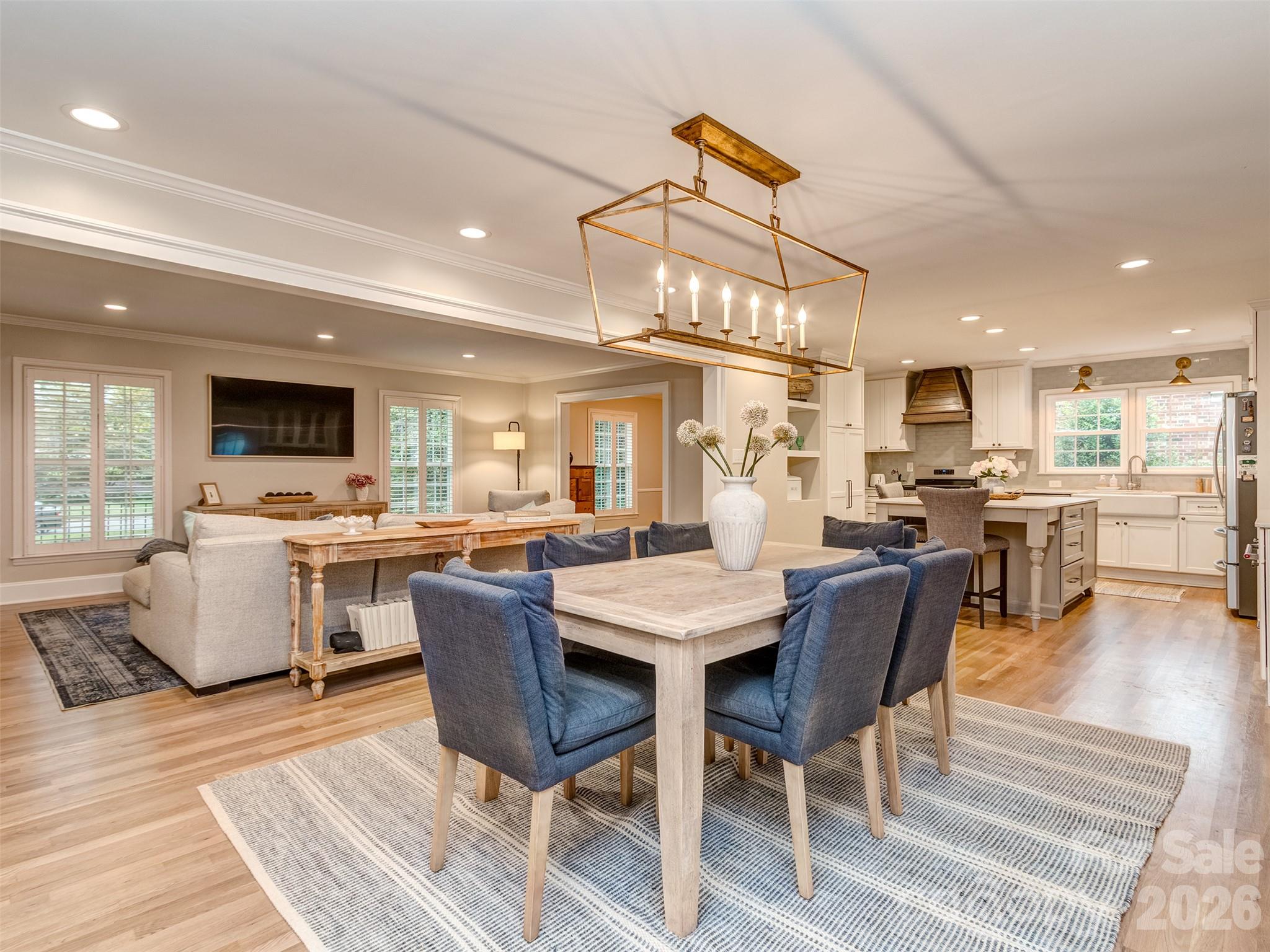 The formal dining room has custom light fixture, gas log fireplace, site finished hardwood flooring, & is perfectly situated between the kitchen, great room, & screened porch! - 6129 Page Court, Charlotte
