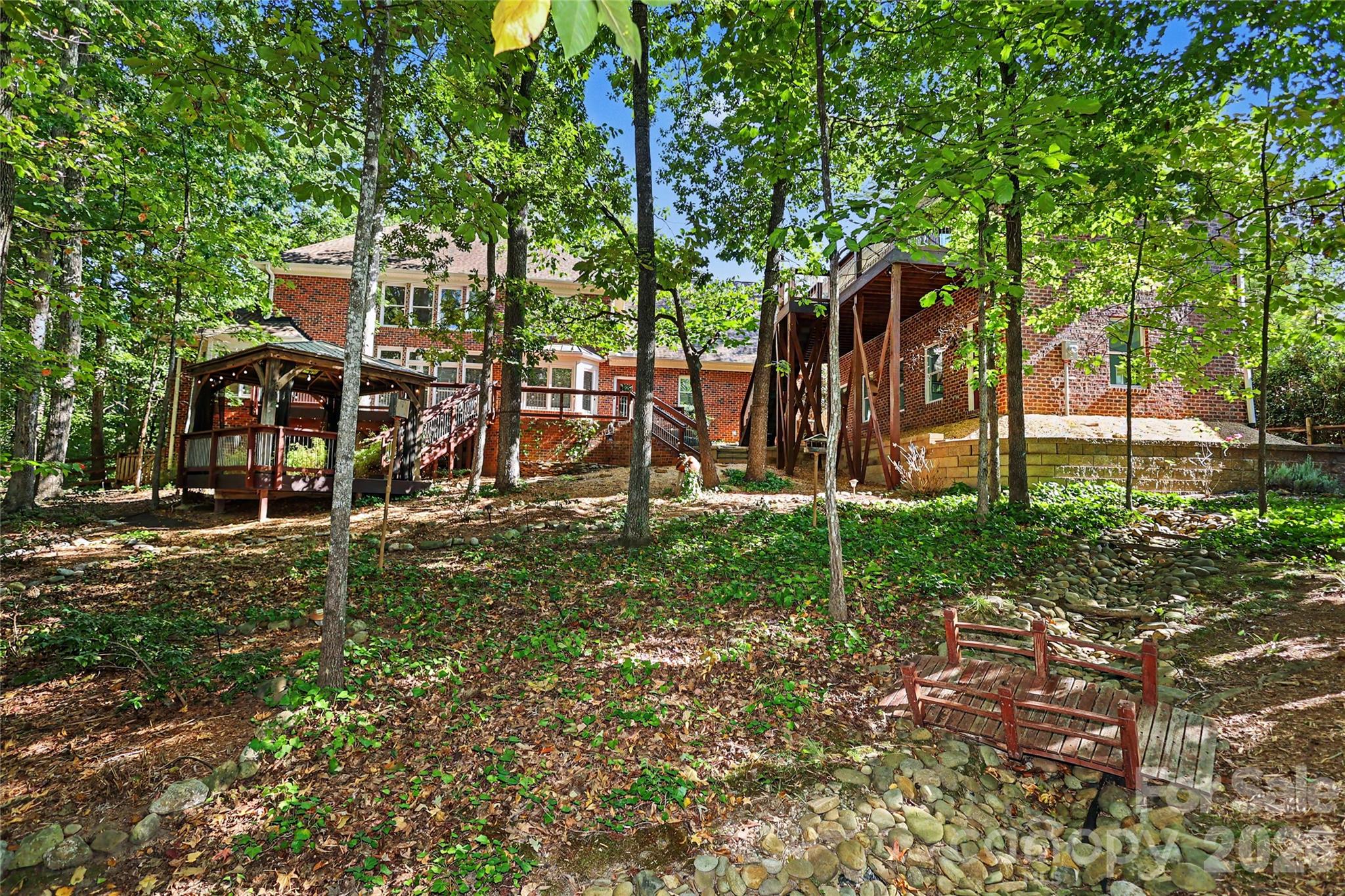 Private yard with mature landscaping on a .72 acre lot - 4320 Town And Country Drive, Charlotte
