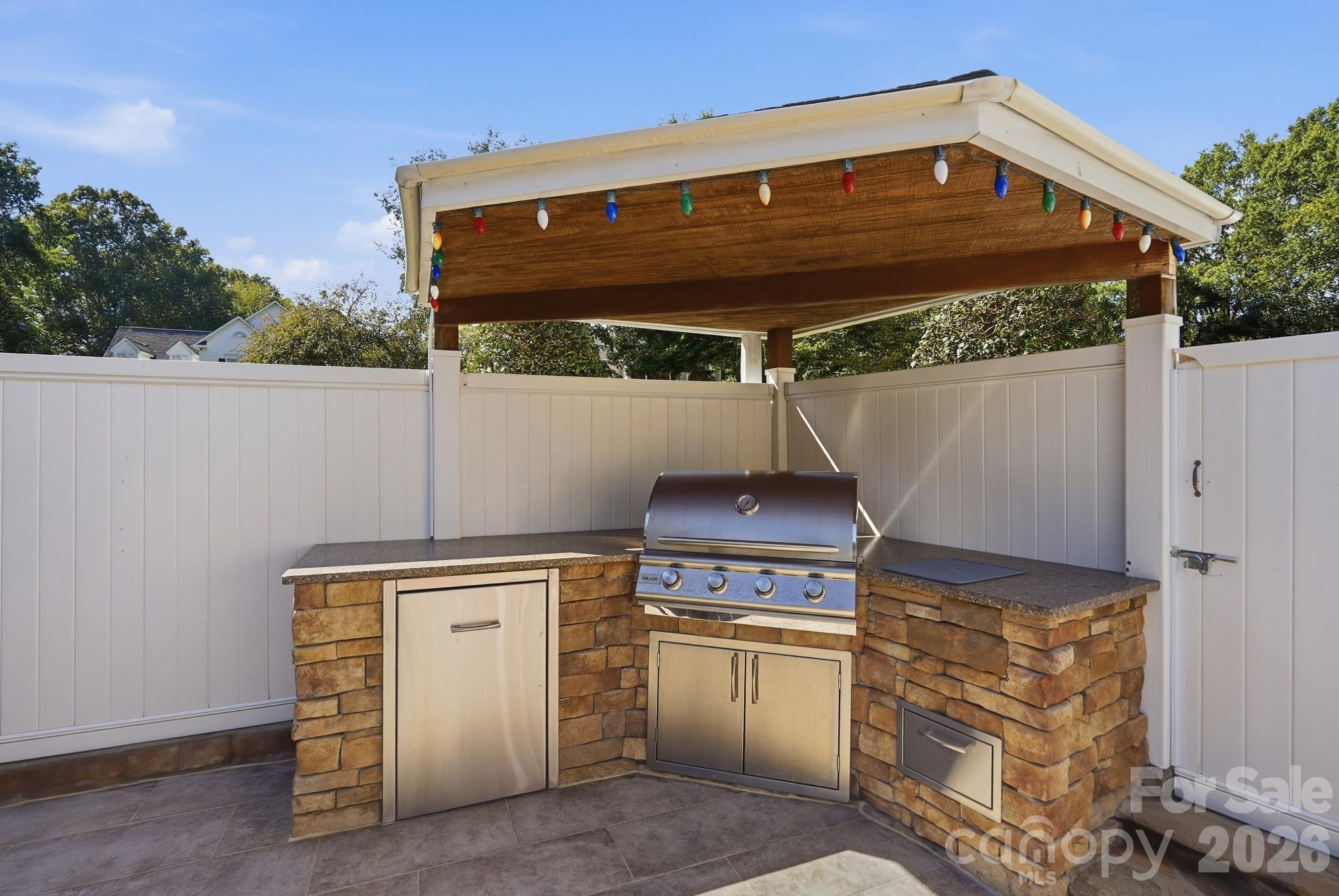Built in outdoor kitchen with overhead protection from the elements while cooking. - 120 Harris Farm Road, Mooresville