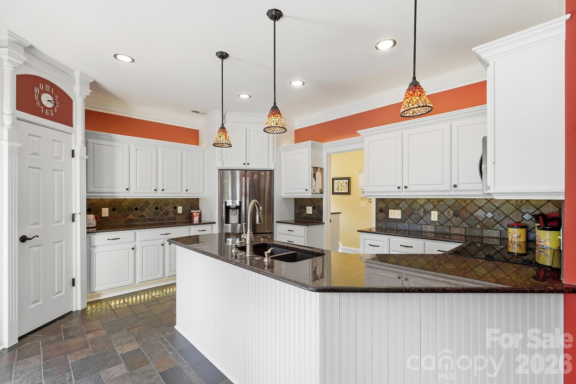 The kitchen has been fully updated and customized. From the slate floors to the counter tops, the reconfiguration of appliances and custom wood work....this kitchen is a chef dream! Bonus that there is under cabinet lighting at the base of all the lower cabinets, under the upper cabinets and also above them. Gorgeous at night! - 120 Harris Farm Road, Mooresville