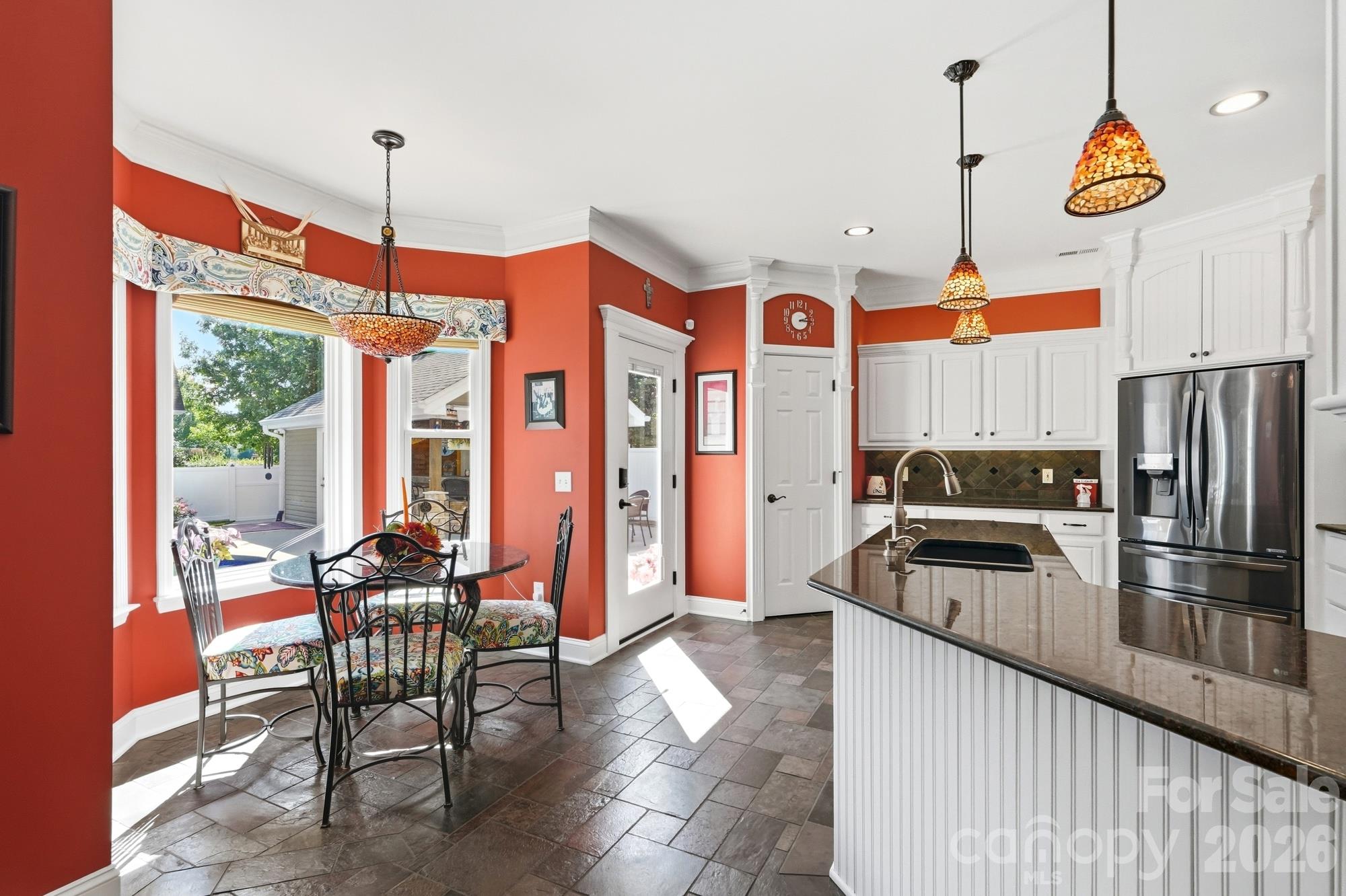 Open kitchen and breakfast area overlook the backyard oasis. The walk-in pantry is such an added bonus too! - 120 Harris Farm Road, Mooresville