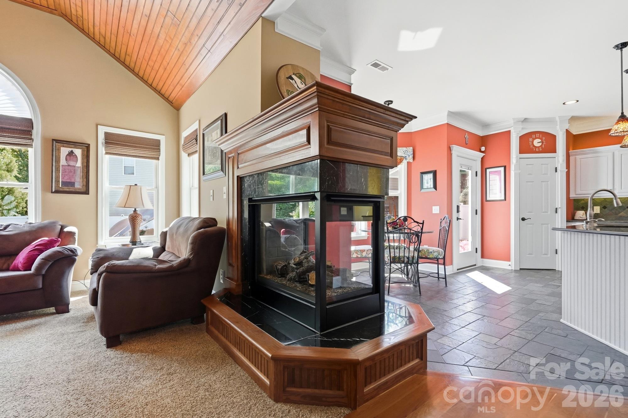 The 3 sided fireplace is gorgeous and provides ambiance to both the great room and the kitchen. - 120 Harris Farm Road, Mooresville
