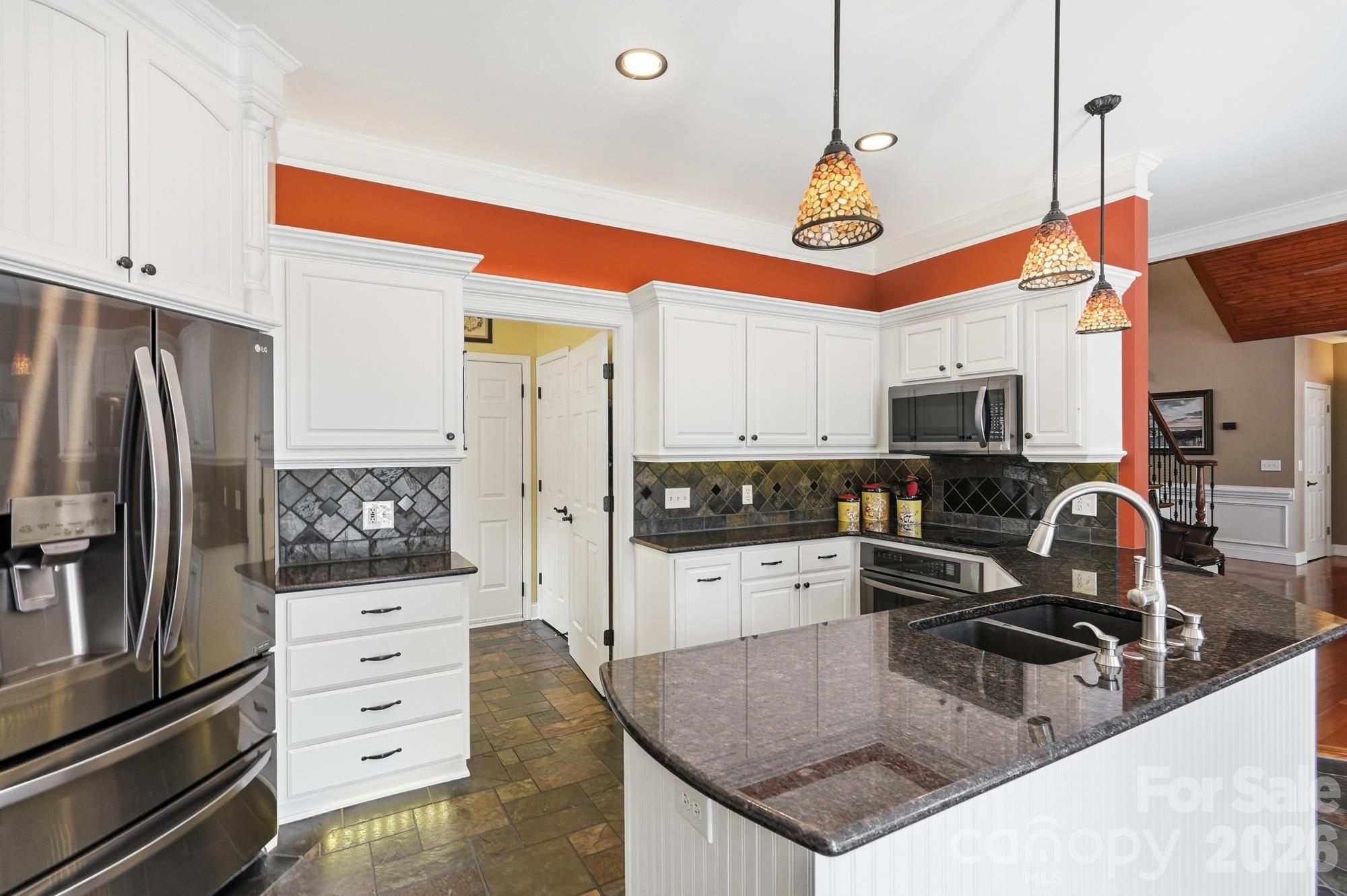 Kitchen with laundry room access (which also has the door to enter the garage) and overlooks the eating area and great room. - 120 Harris Farm Road, Mooresville