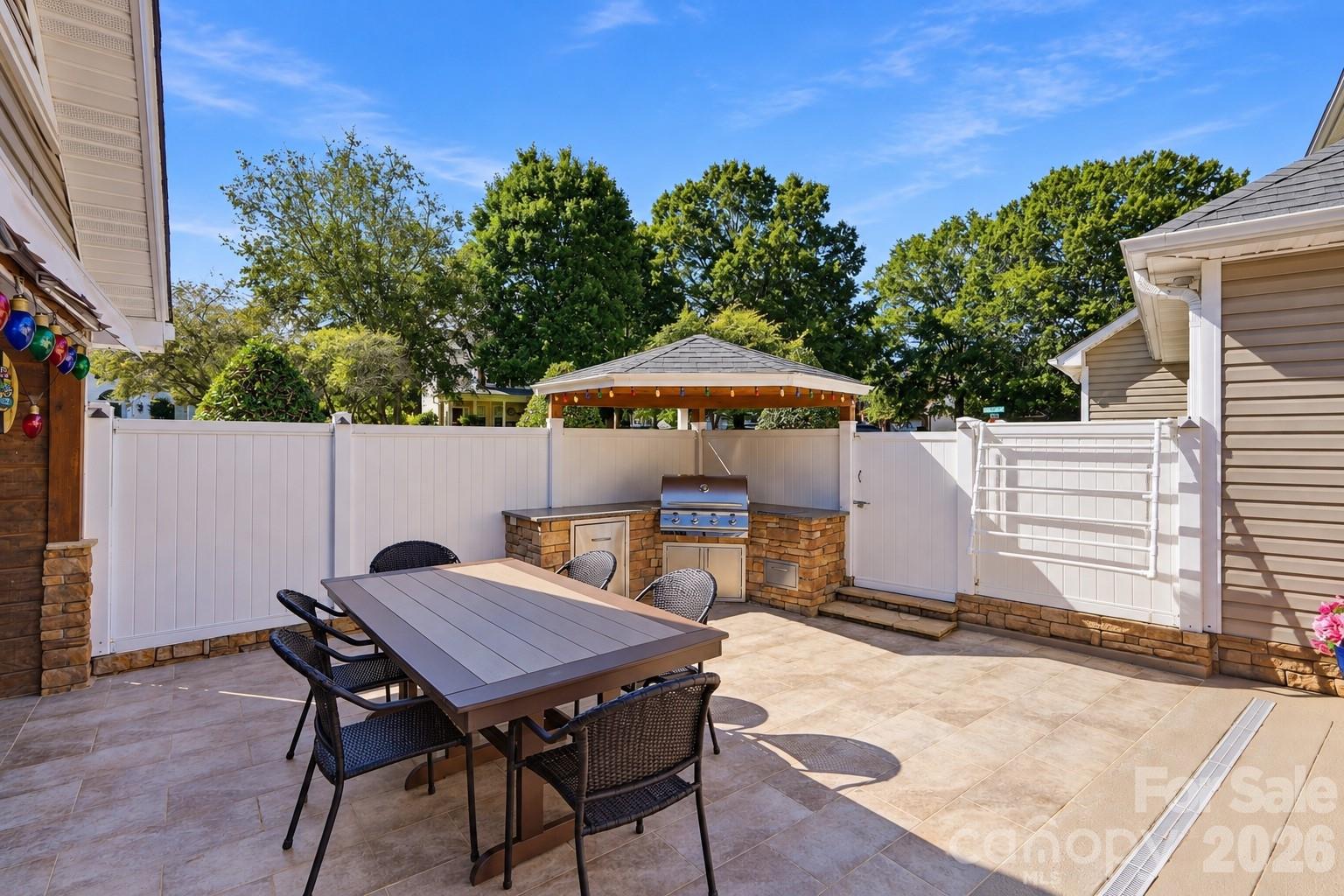 Outdoor eating/cooking area with pool towel drying rack. - 120 Harris Farm Road, Mooresville