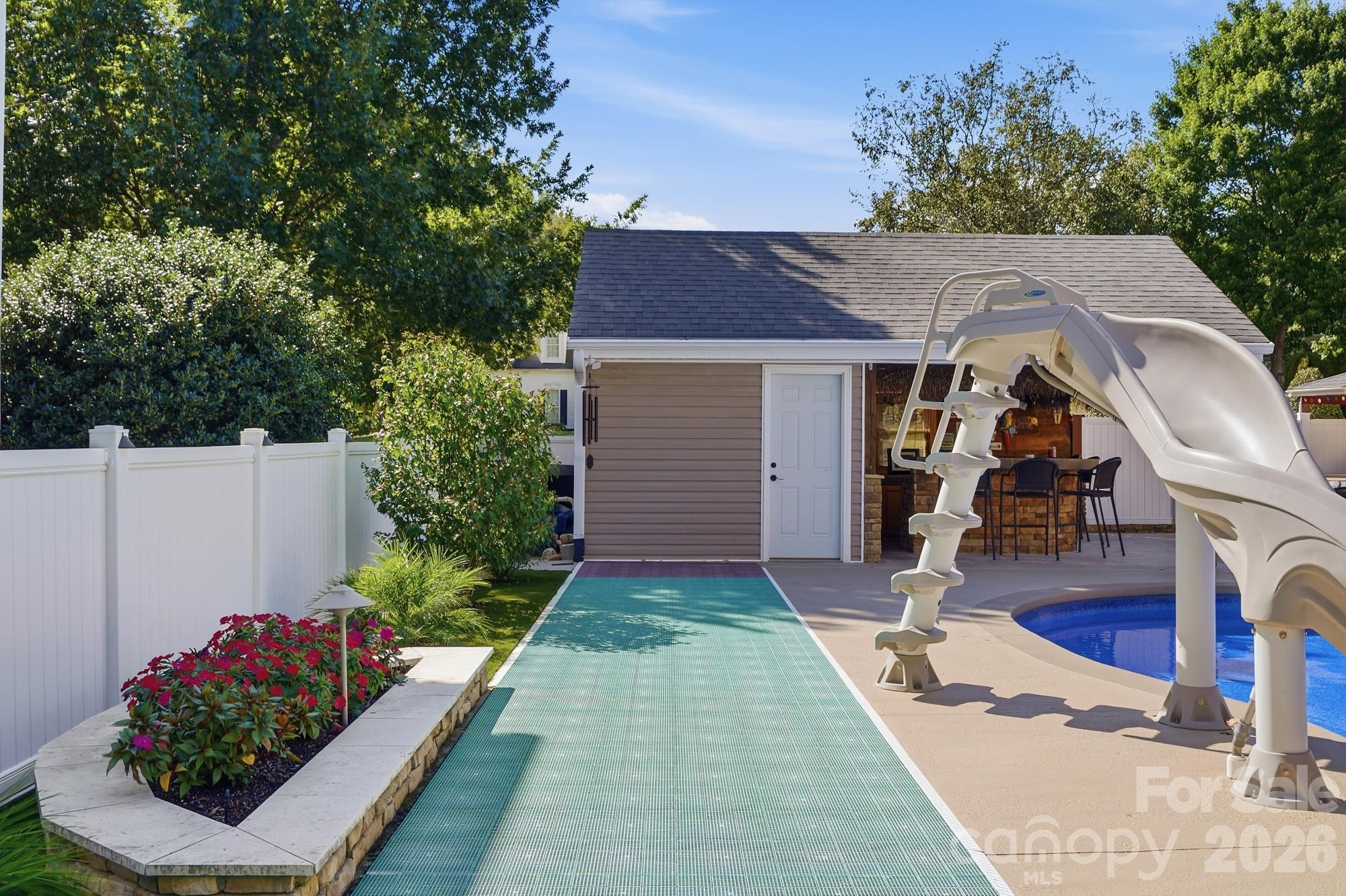 Backyard shuffleboard & pool slide provide fun for hours of entertainment. All raised beds in the pool area are irrigated with the irrigation system. - 120 Harris Farm Road, Mooresville